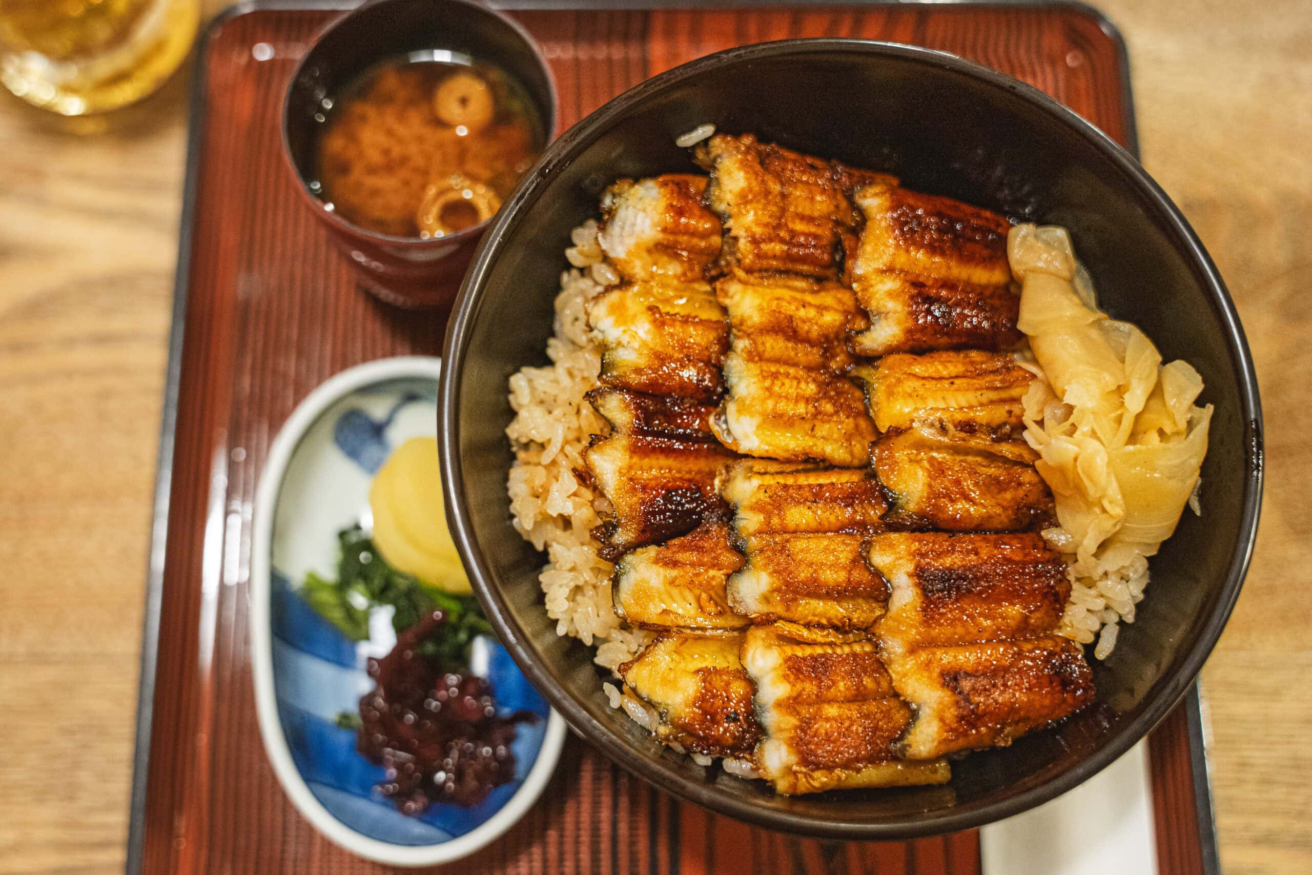 A bowl of grilled eel and rice, served with slices of ginger, pickles and miso soup that we had for dinner at Ueno Anagomeshi Miyajimaguchi Honten