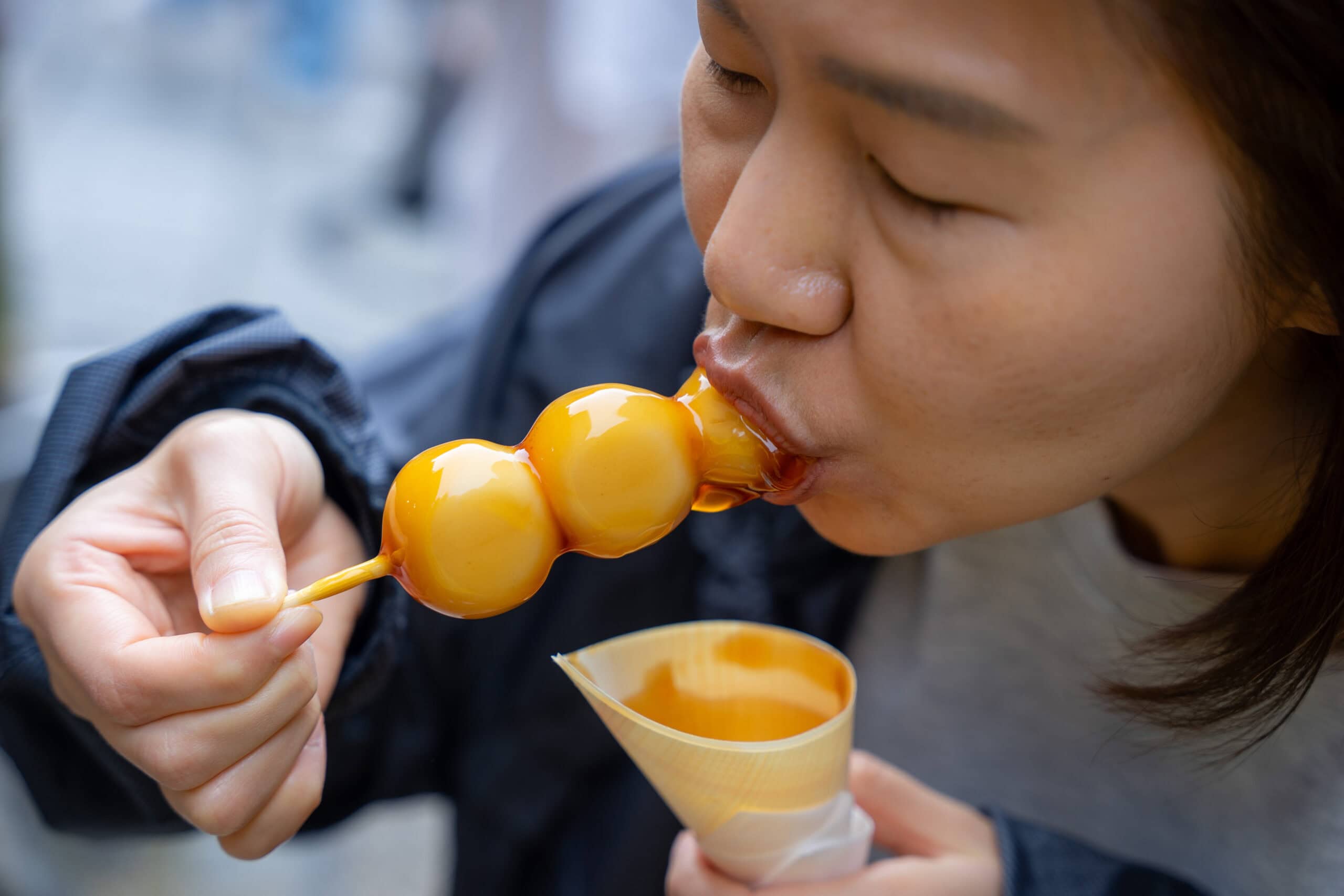 Jin eating Mitarashi dango