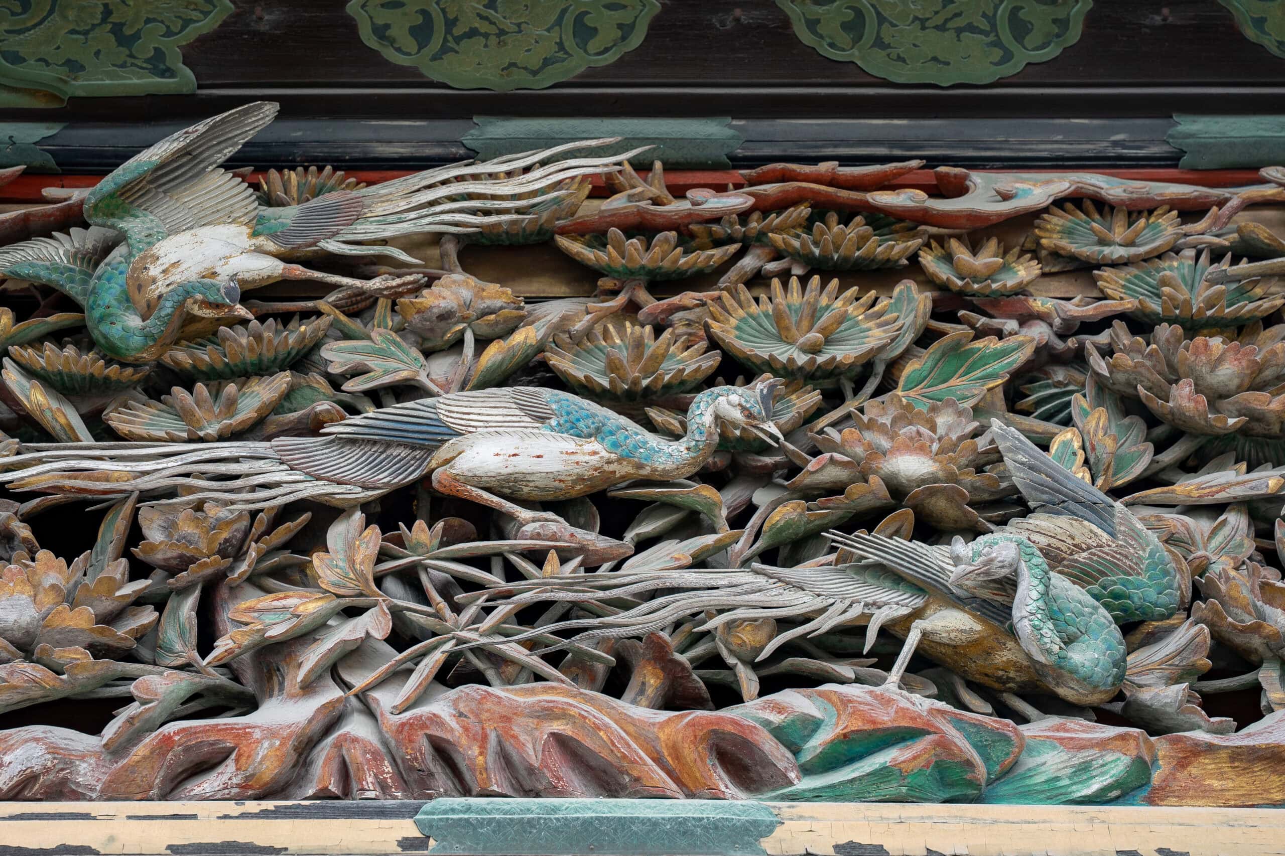 Detail of carved wooden peacocks and flowers seen on the entrance of the Ninomaru Palace at Nijo Castle, Kyoto