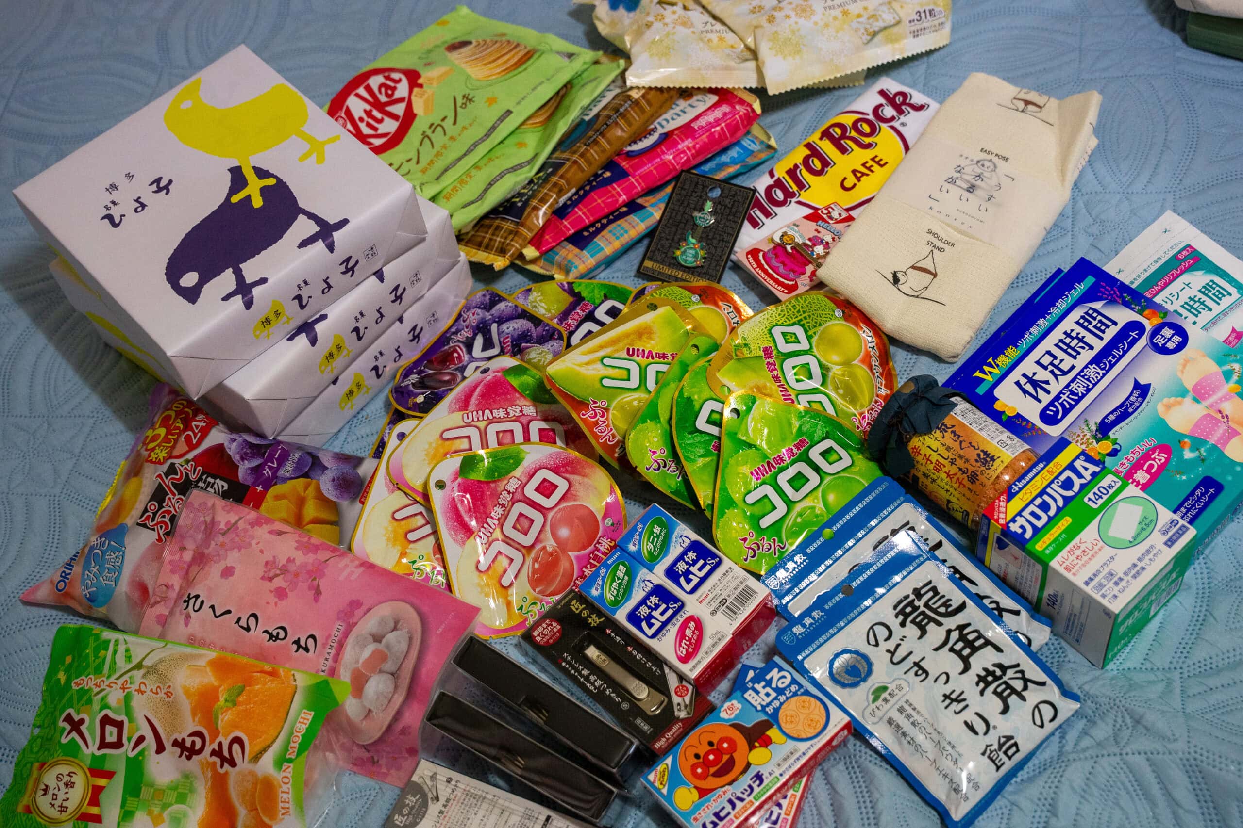 All the things Jin bought in Osaka. There are cndy and band-aids, and nail clippers and a tshirt, and kitkats in various flavours