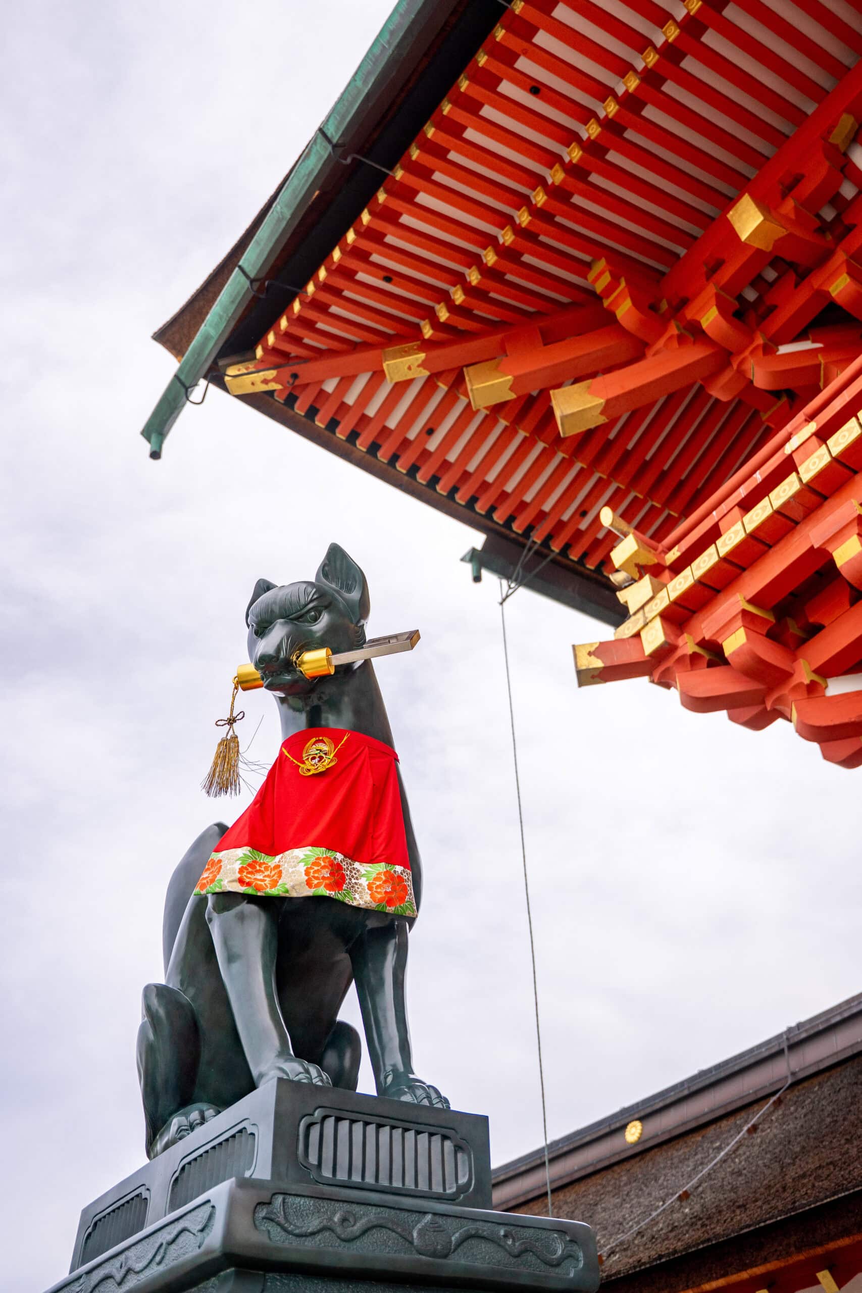 A kitsune (fox) seen holding a key in its mouth at Fushimi Inari