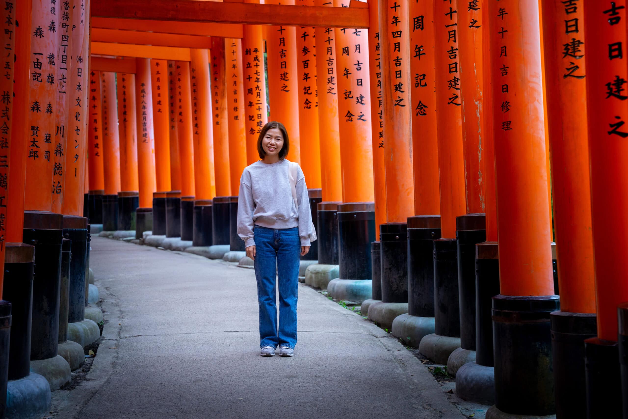 Jin poses for a photo in the tuneel of torri gates during our Fushimi Inari hike