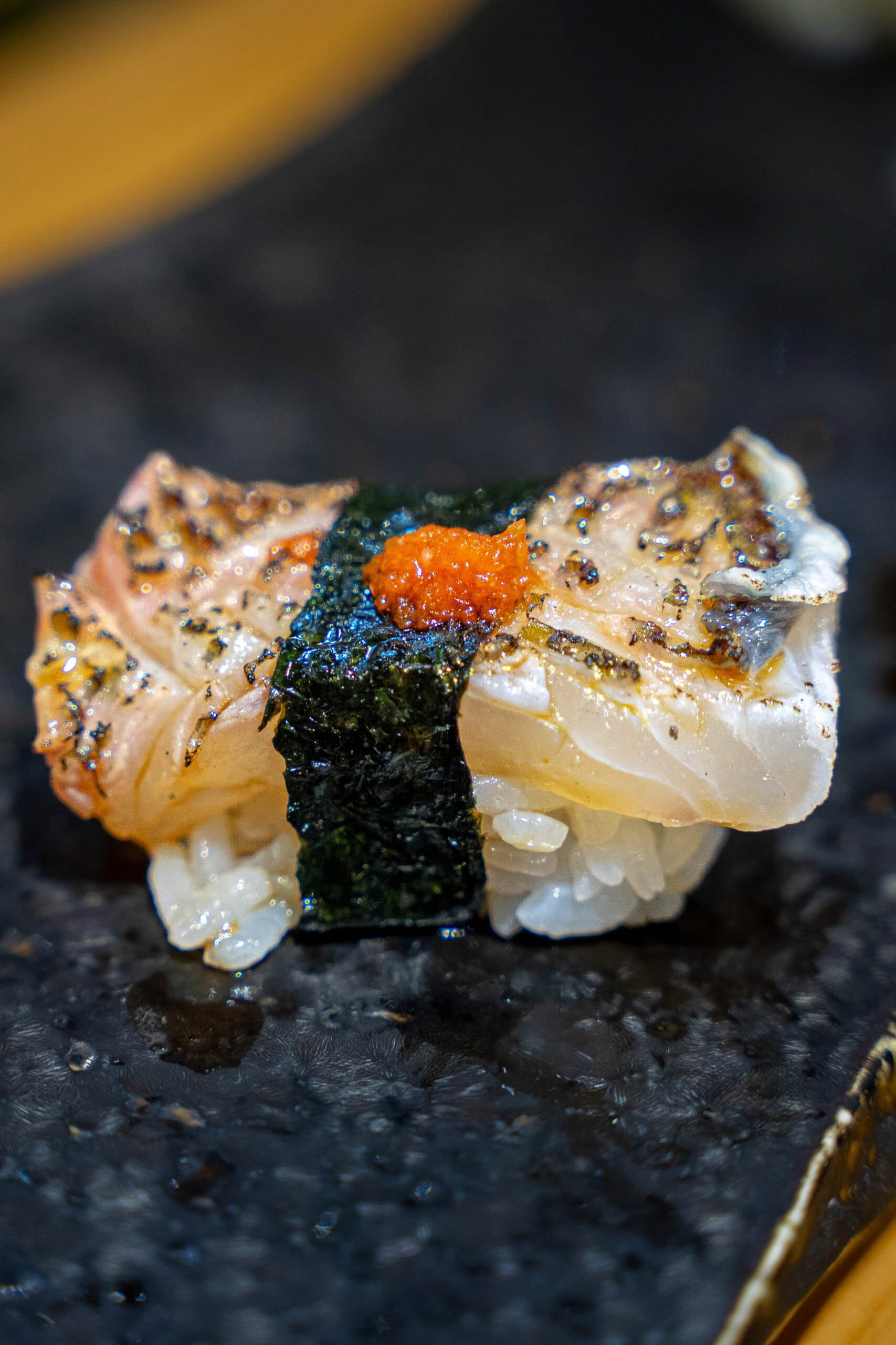 a piece of charred fish sushi we had at Sushi Hiro during our first lunch in Osaka
