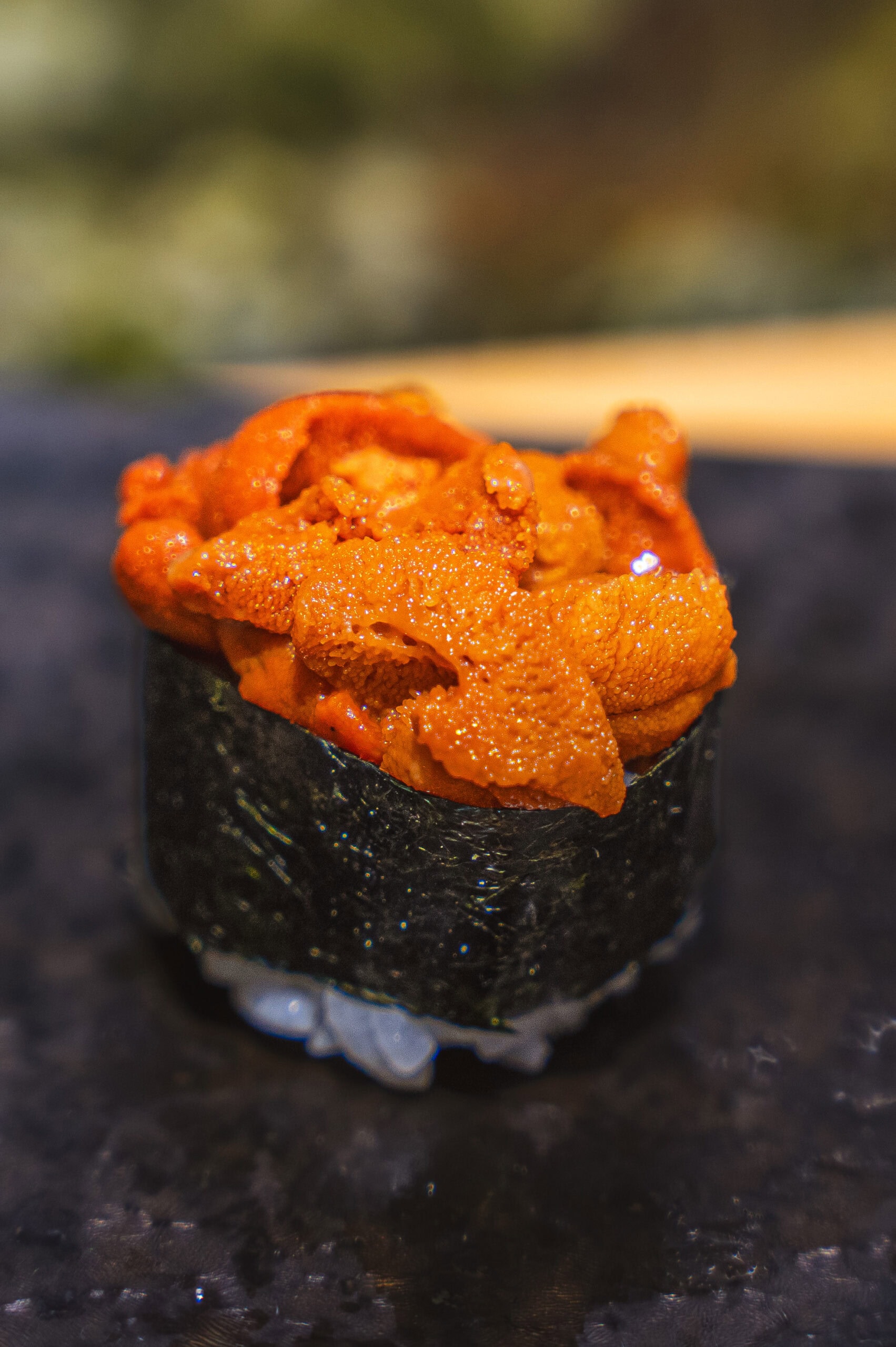 A piece of sushi with sea urchin