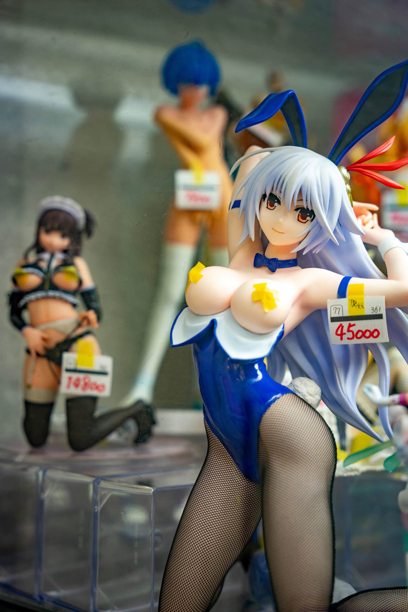 An anime figure in Denden town, Osaka. It's a topless female figurine wearing bunny ears and fish net stockings. It costs 45 000 yen 