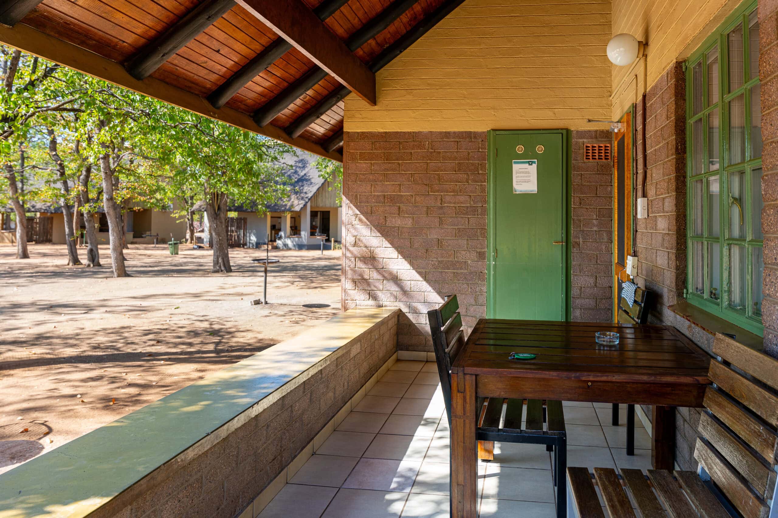 The veranda with a table and chairs at my Hut EH3, Shingwedzi
