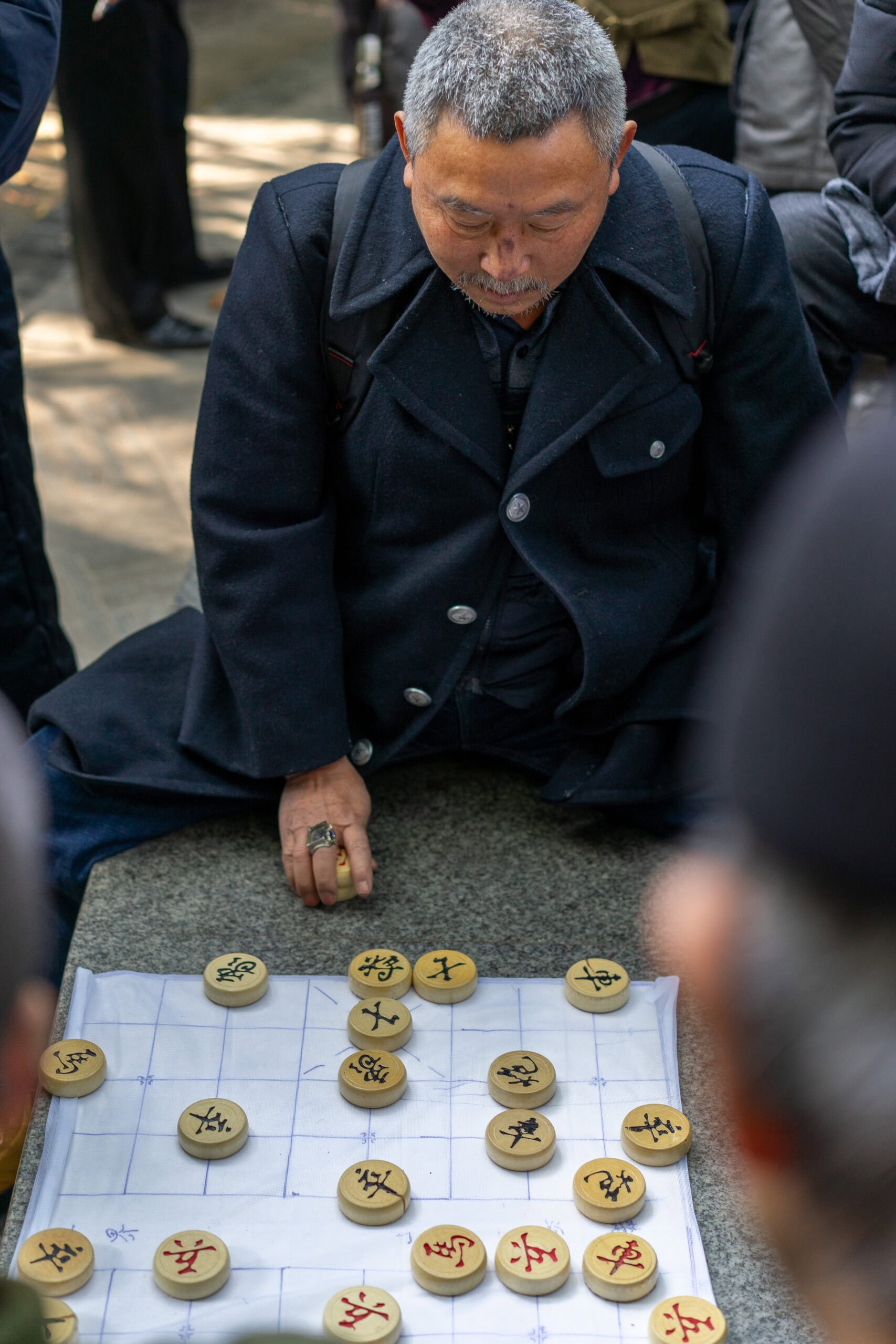 A man plays Chinese chess in a park in China