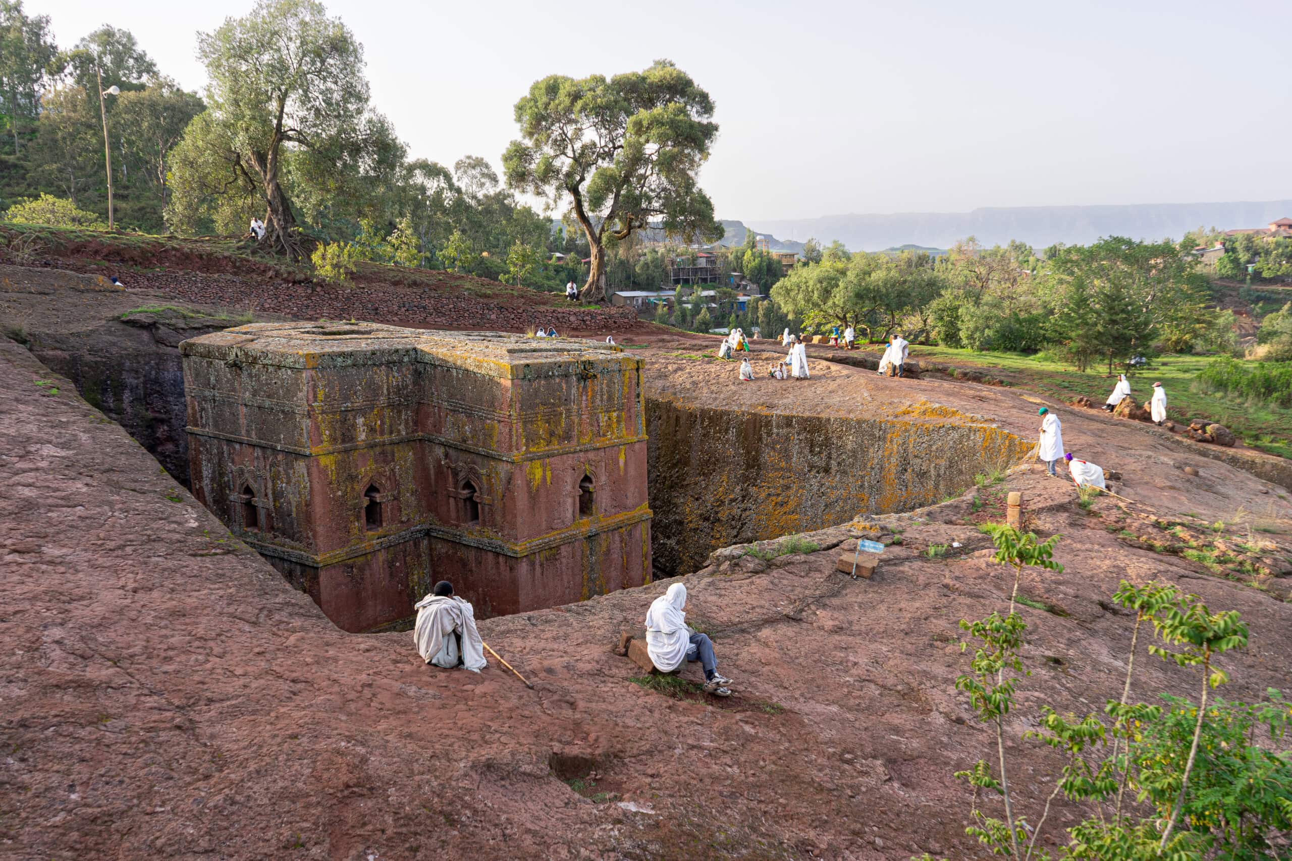 Biet Giyorgis, the church of Saint George, seen early on Sunday morning. A few worshippers are sitting along the rim of the rock hewn church