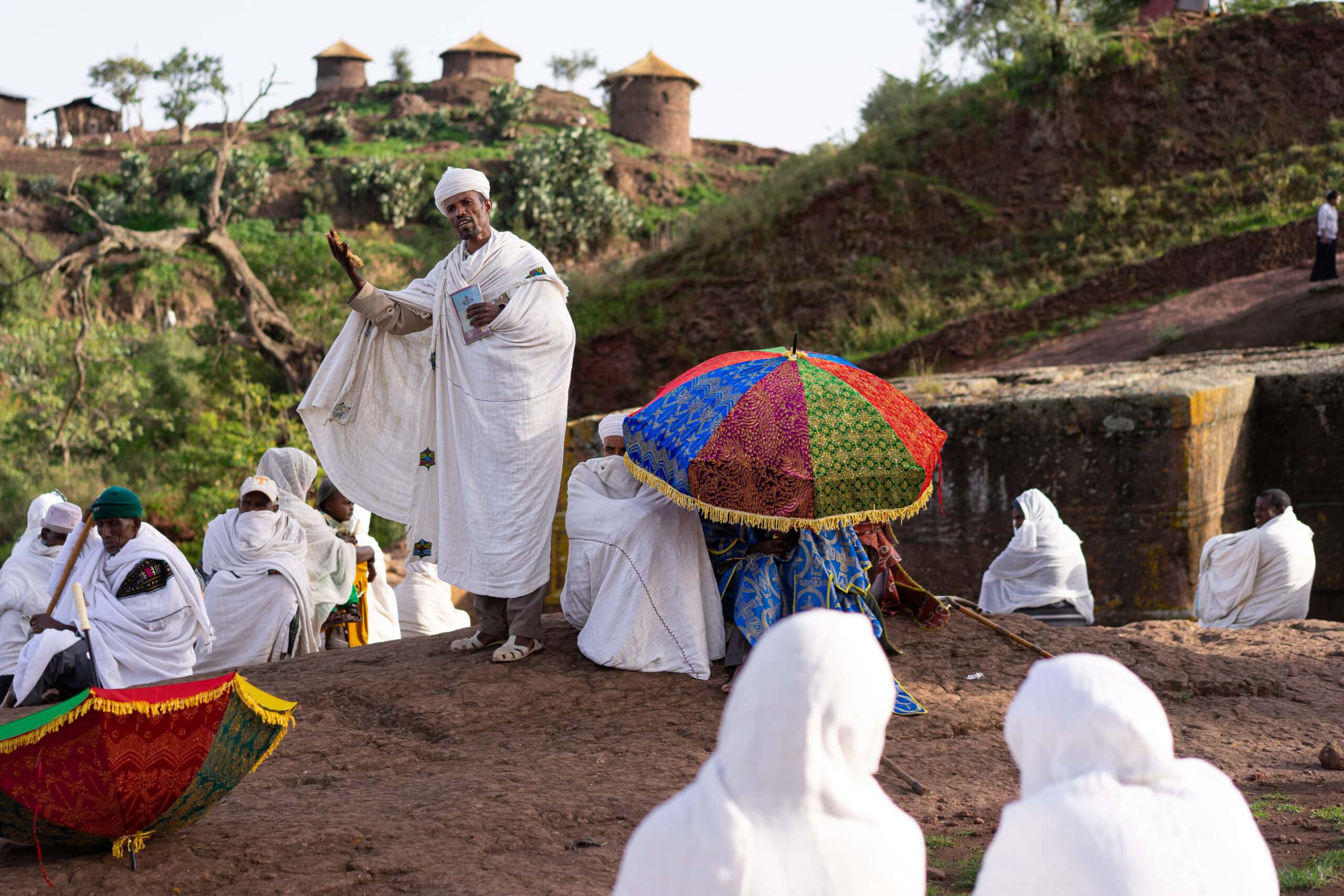 An Ethiopian Orthodox priest gives a sermon outside Biet Giyorgis on Sunday morning, Lalibela