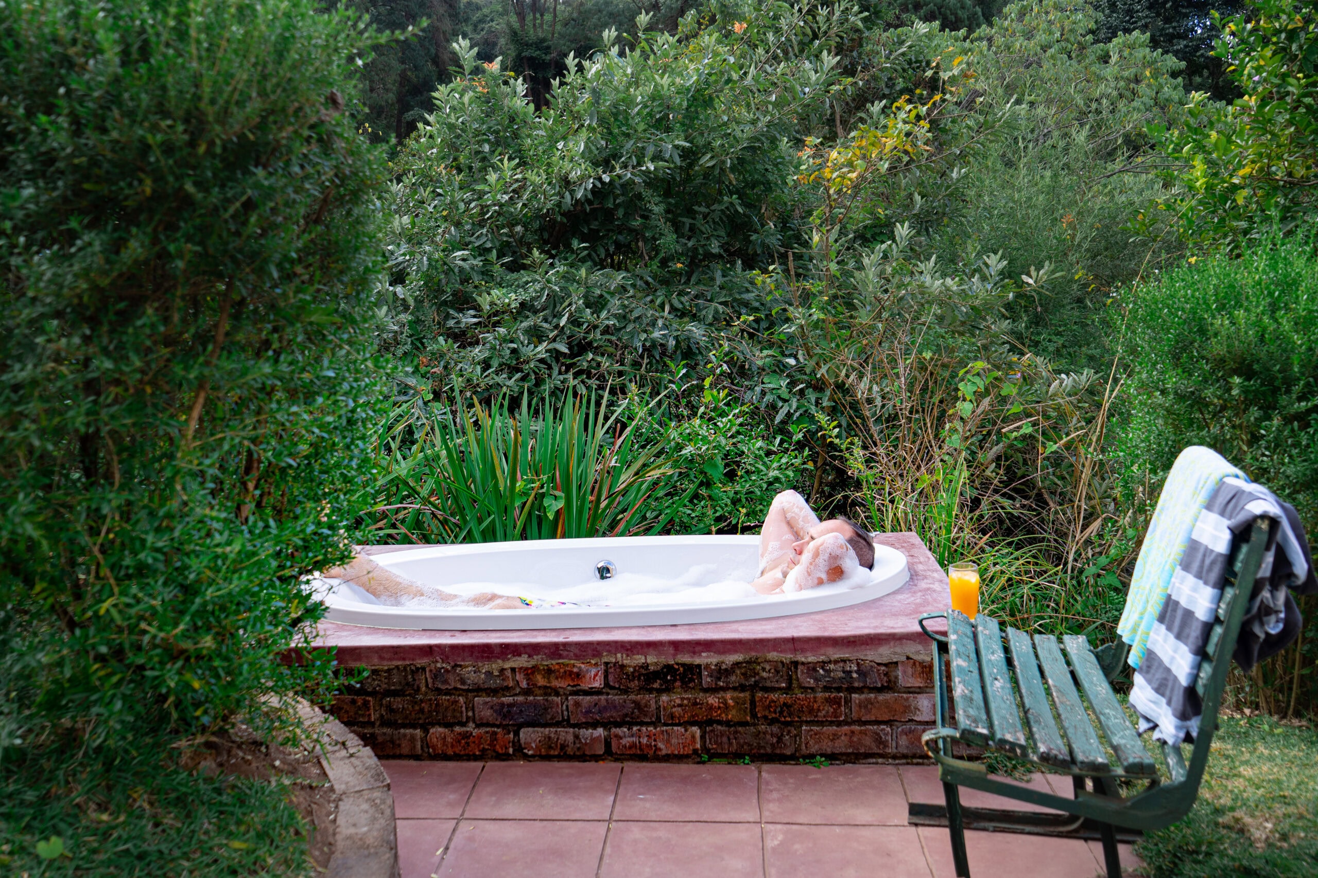 I'm enjoying an outside bath in garden of our accommodation in Magoebaskloof