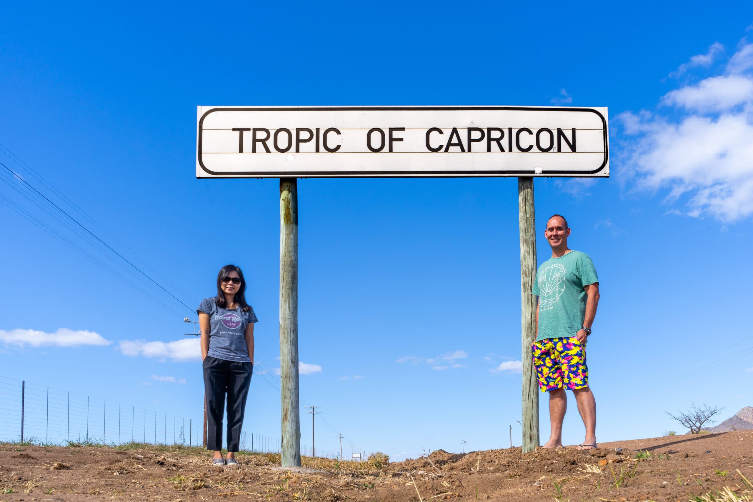 We are posing for a photo next to the Tropic of Capricorn road sign on our Limpopo Road Trip, South Africa