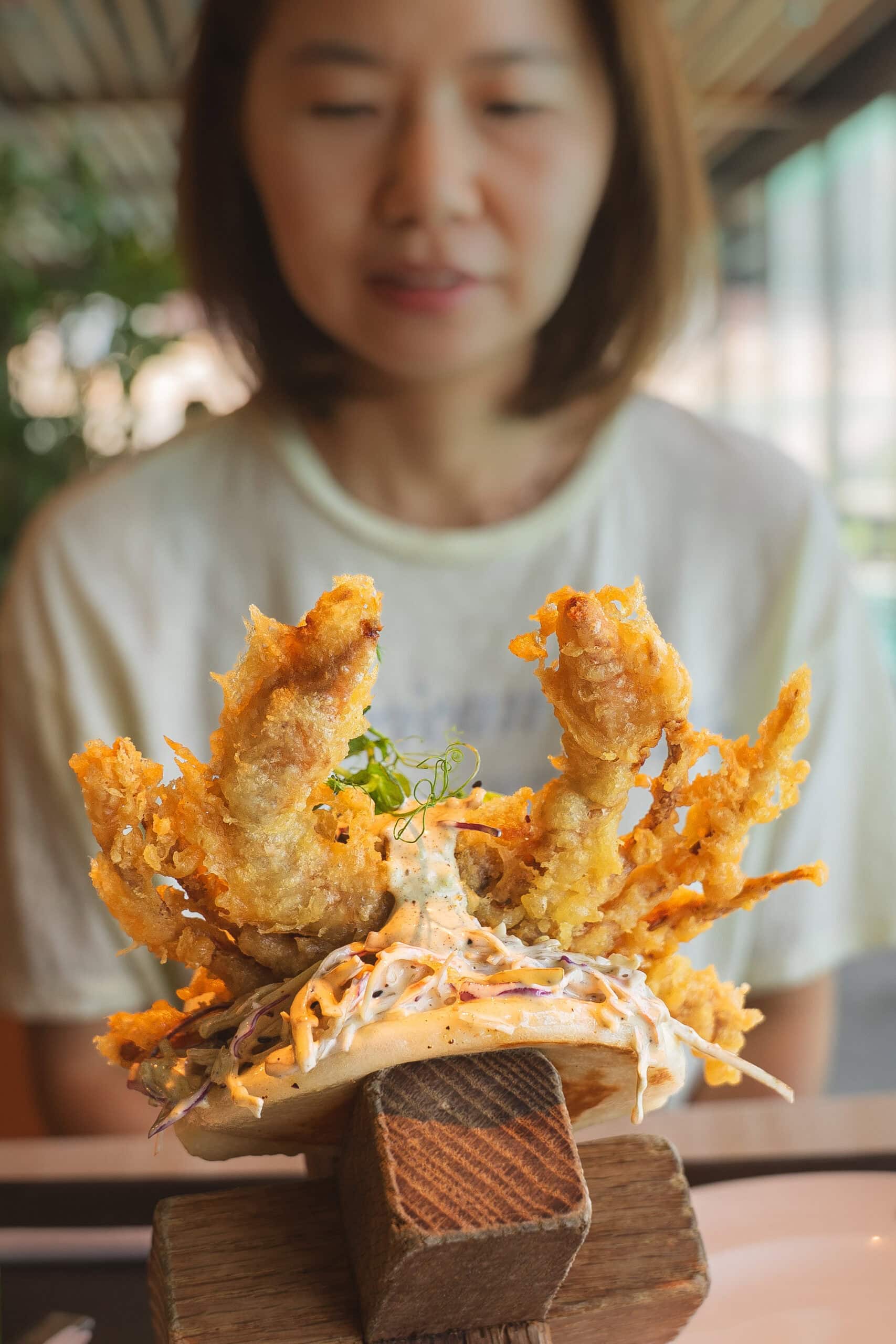 Jin with a soft shell crab bao bun at Time Out Market in Dubai