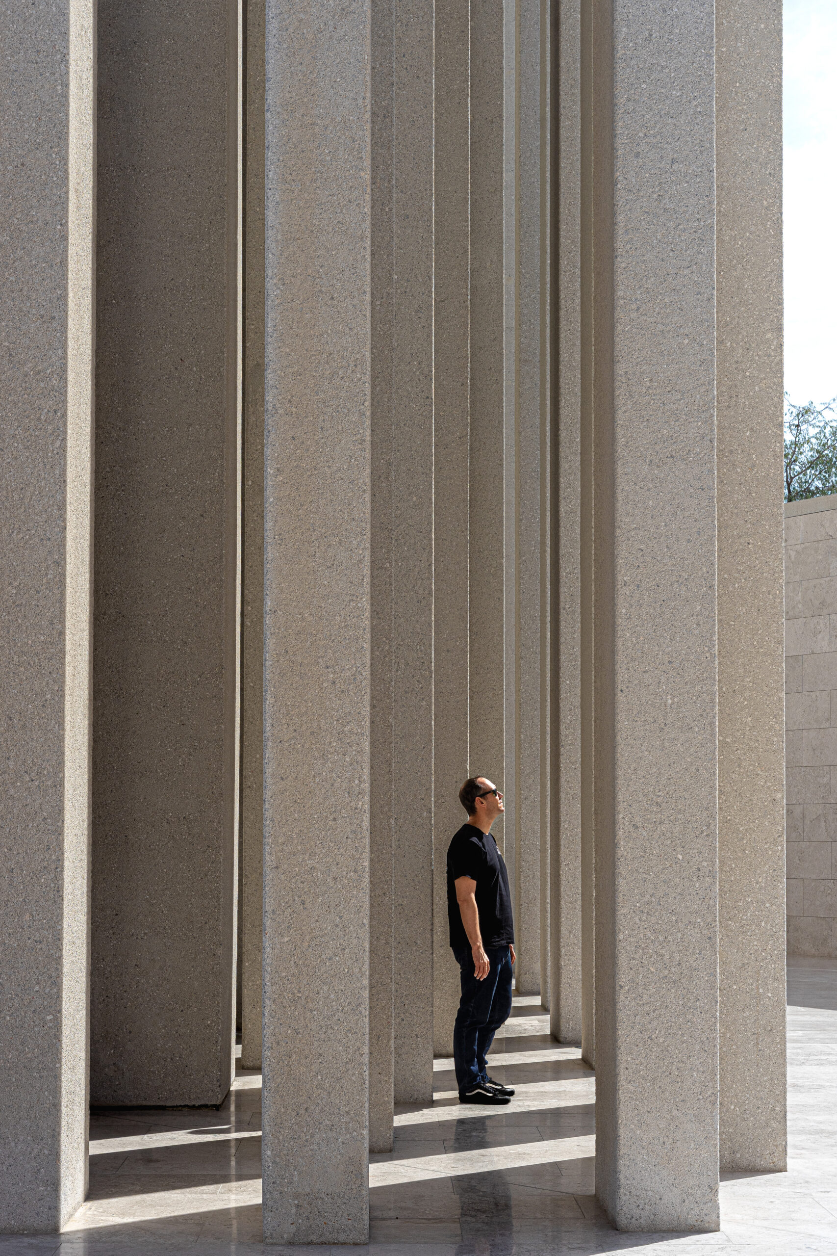 I am standing between the tall, slender columns of the church at the Abrahamic Family House Abu Dhabi