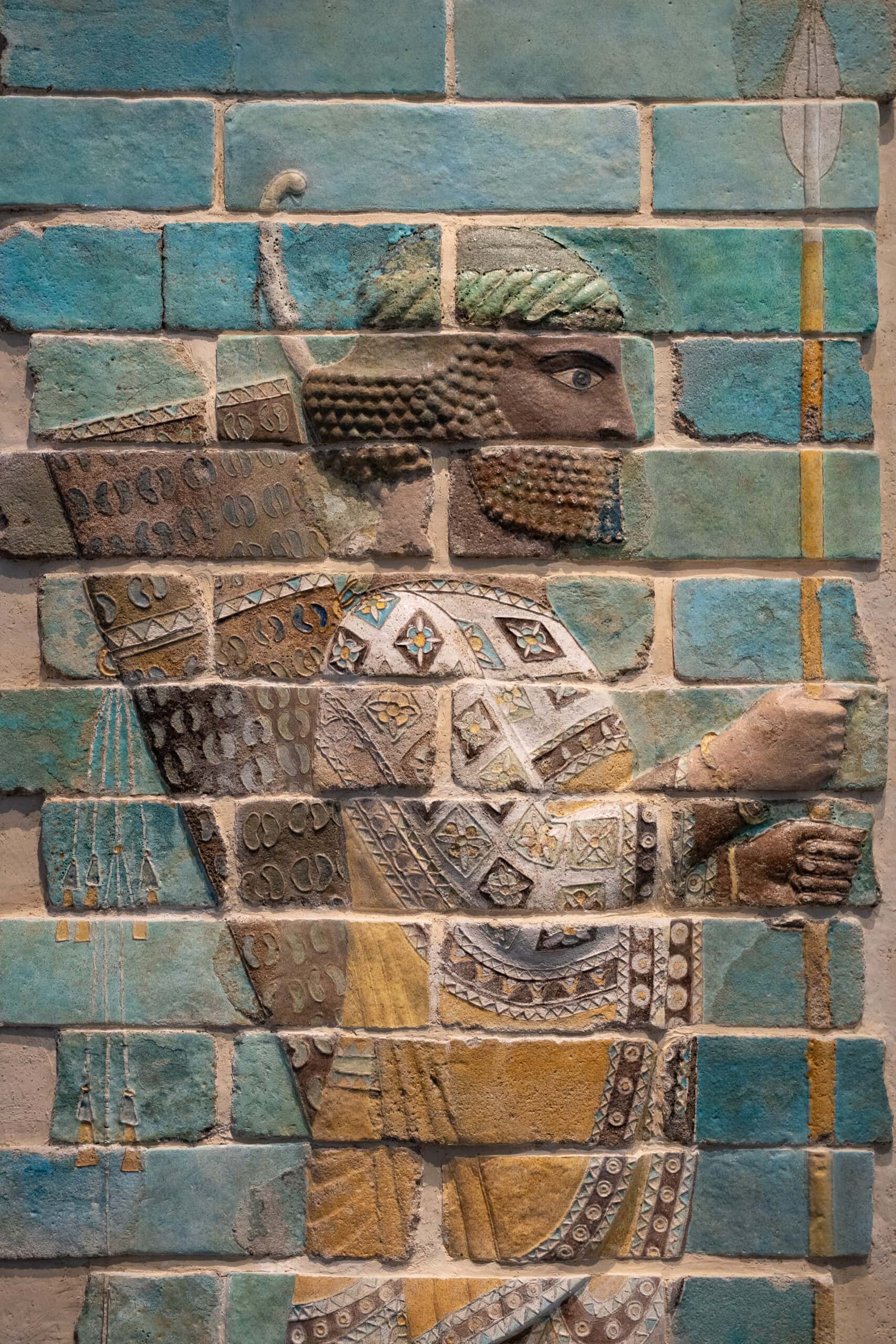 A wall panel from Iran depicts a soldier holding a spear, seen in the Louvre Abu Dhabi