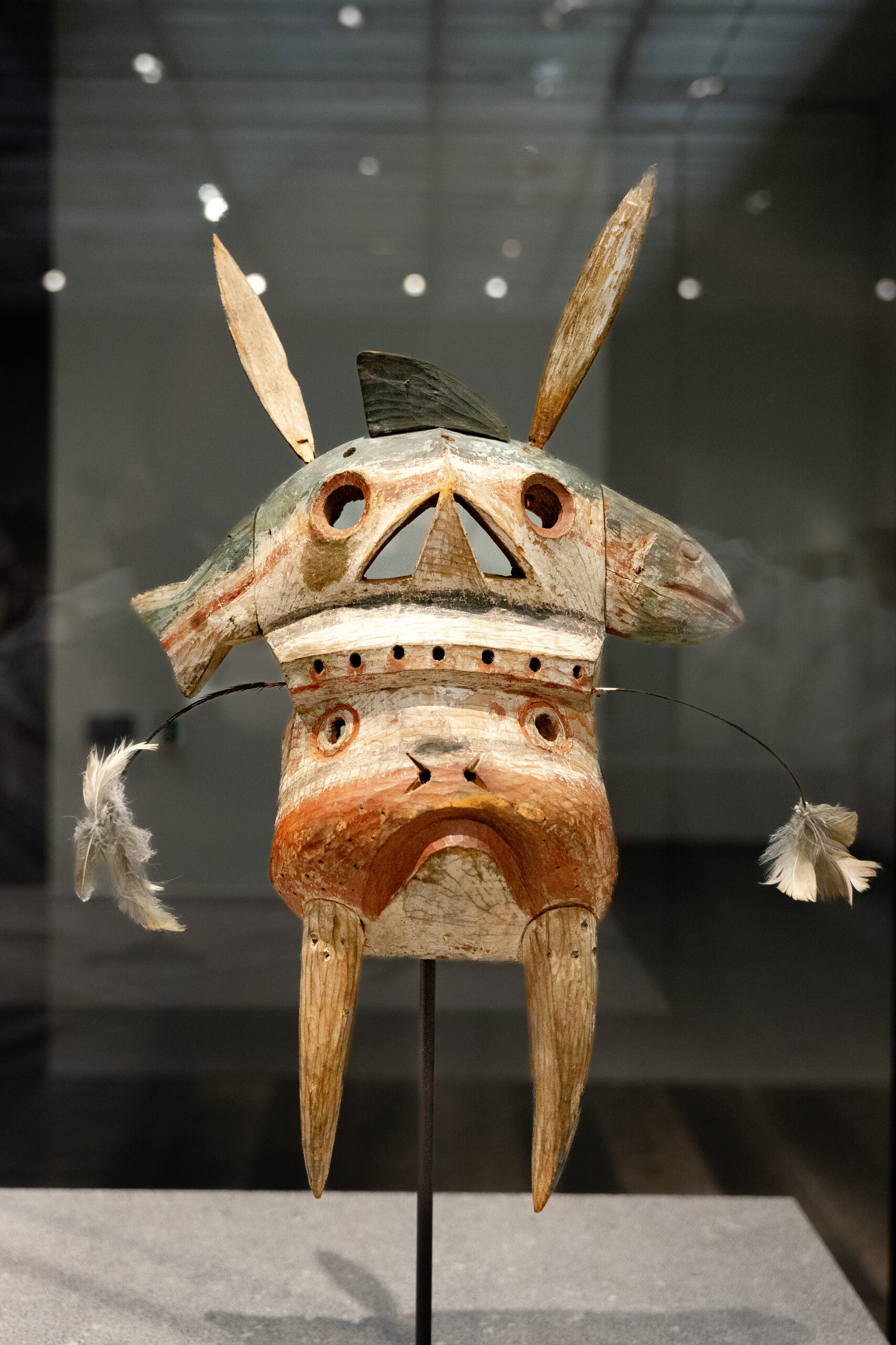 A wooden mask, shaped like a walrus and a fish