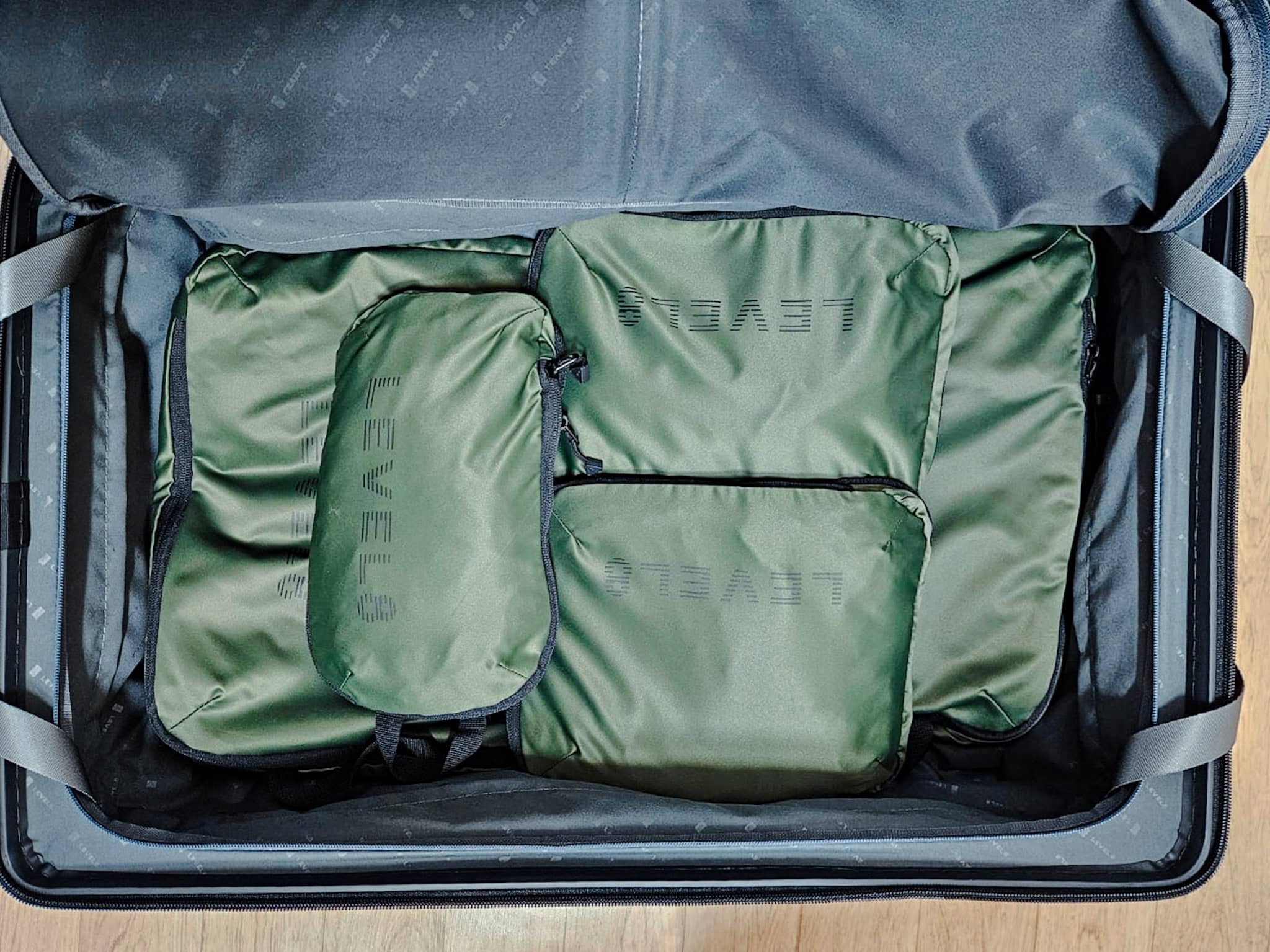 The packing cubes filled with clothes inside the suitcase