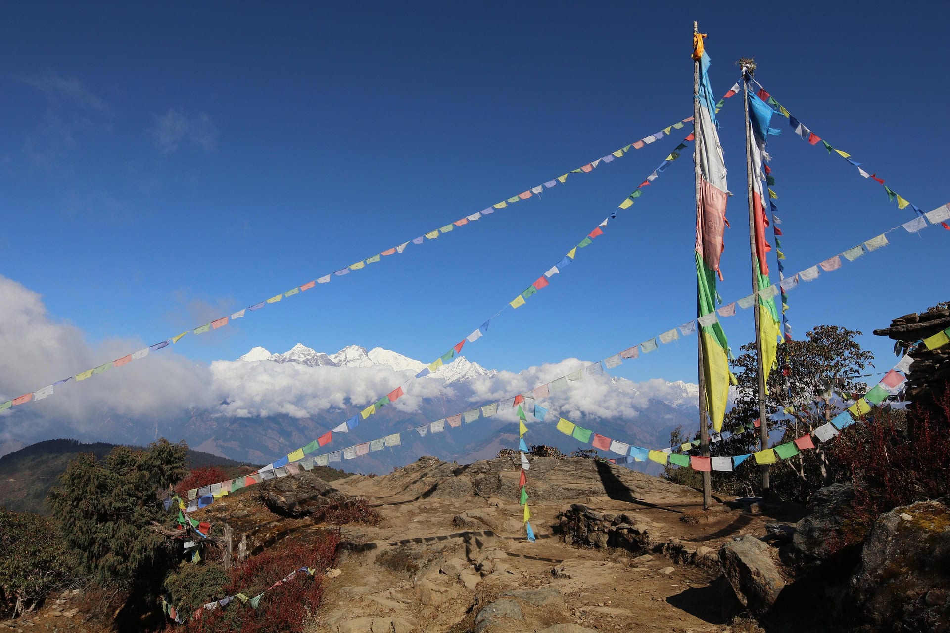 Colorful prayer flags on the  fluttering in the wind with Himalayan mountains in the background.