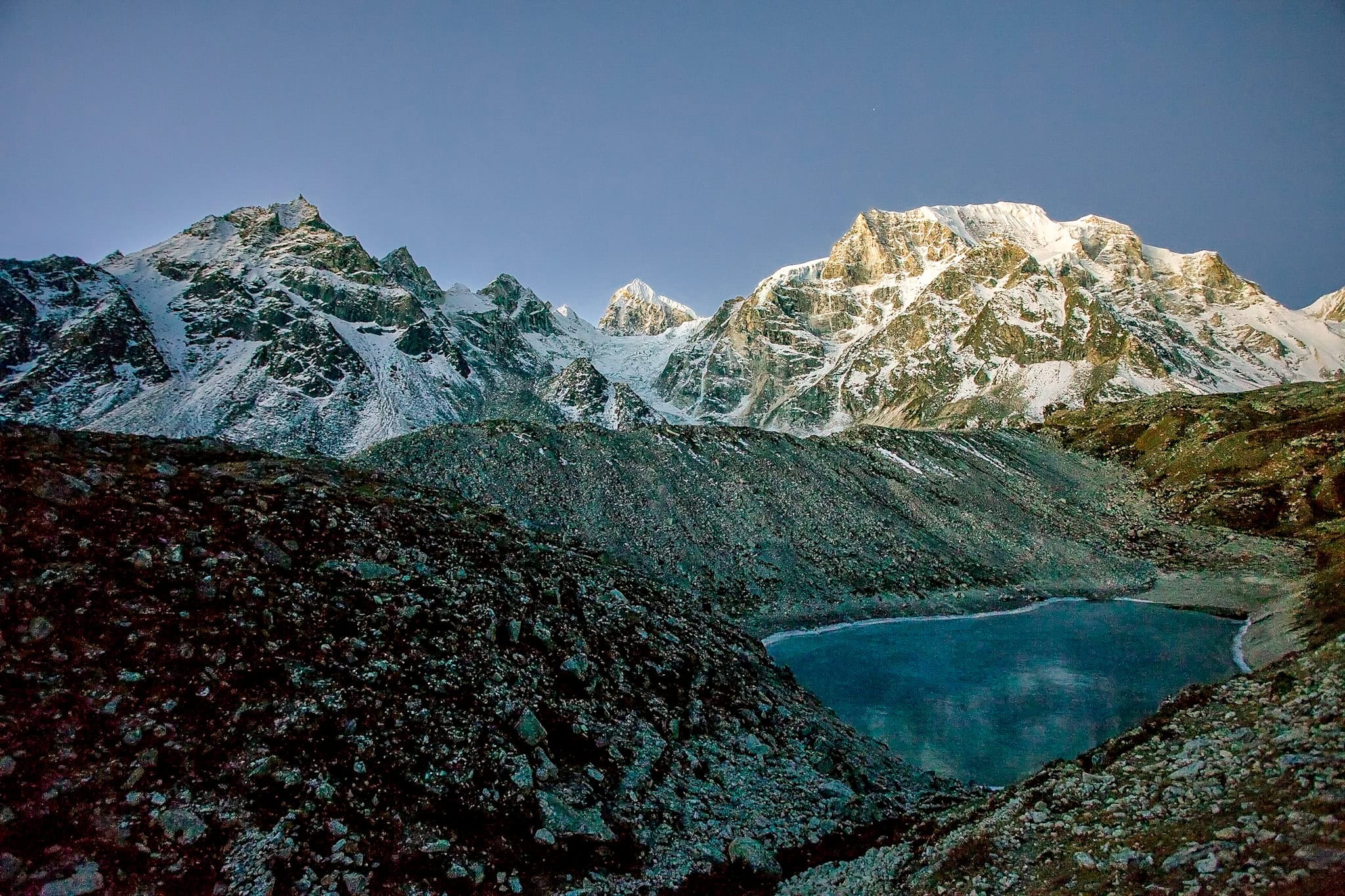 Snow-capped mountain range and alpine lake at dusk, scenic landscape at Museum of Wander.