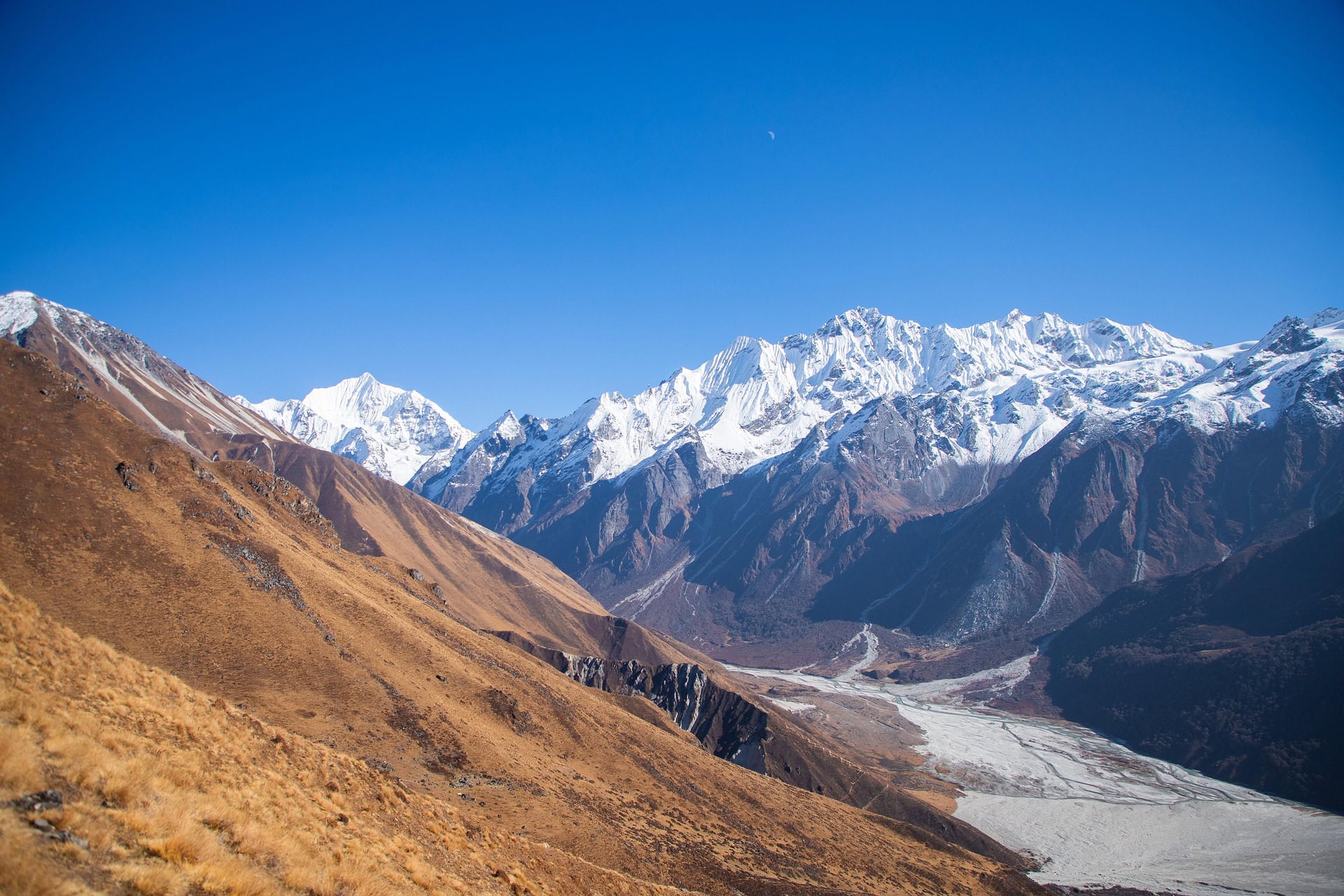 Snowy Himalayan peaks seen across a valley in Langtang National Park, Nepal
