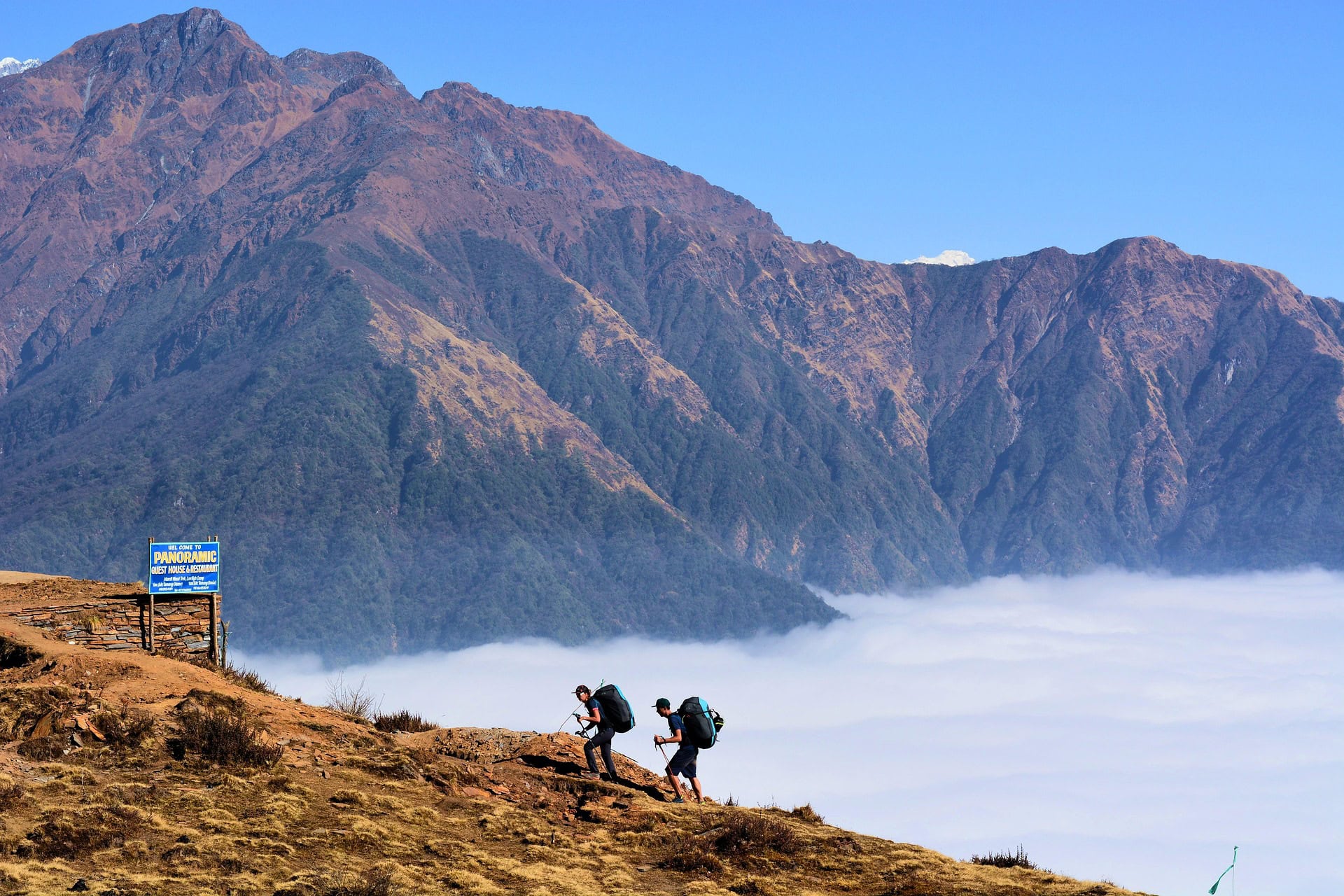 Mountain landscape with two hikers and fog, outdoor adventure at the Nepal Himalaya