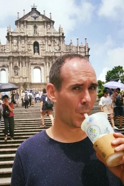 I am drinking bubble tea in front of the St Paul's Ruins in Macau. It looks very hot. The photo was taken in august
