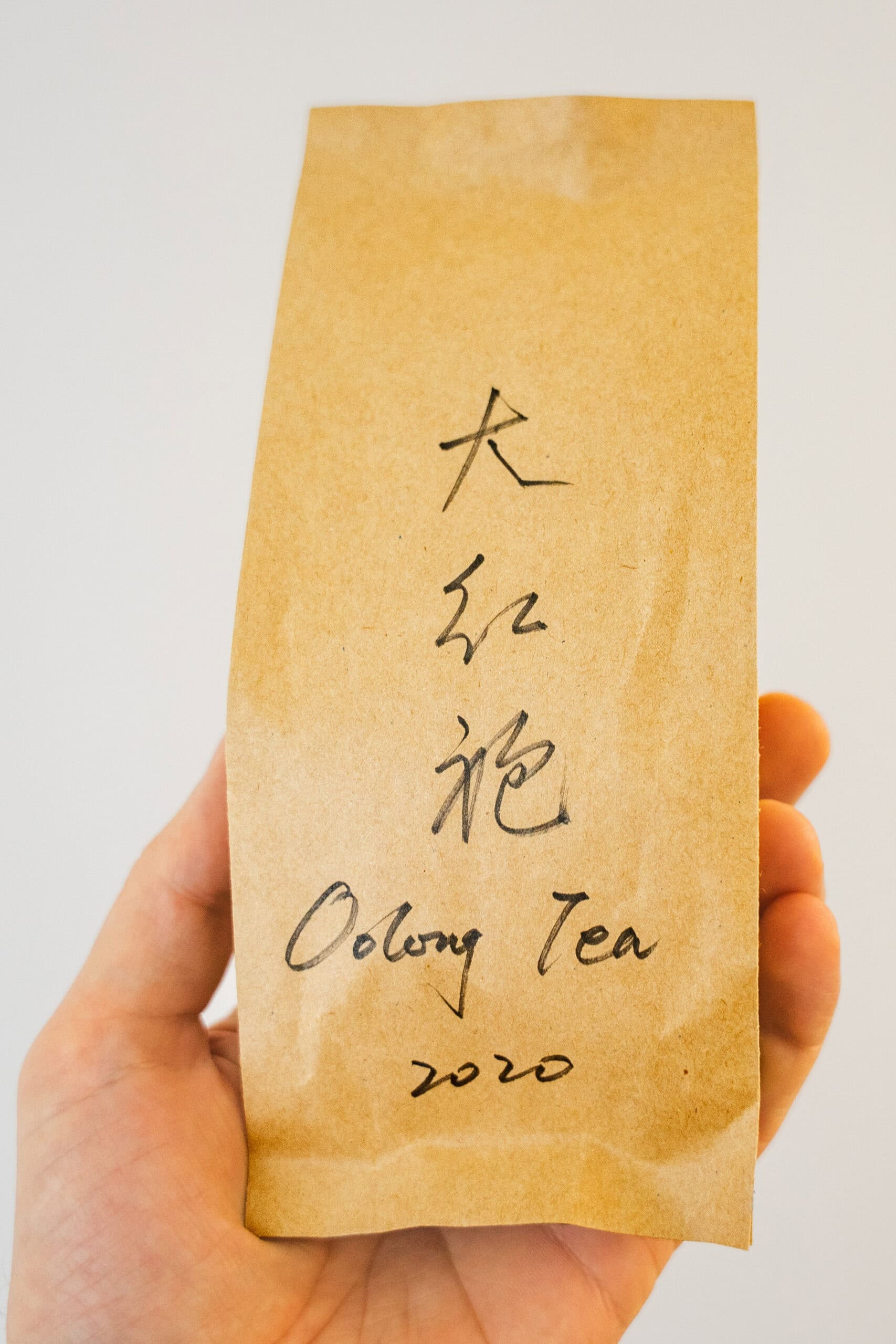 The bag of oolong loose leaf we bought at Tianshan Tea City. The name of the tea is handwritten in Chinese and English, as well as the vintage year 2020