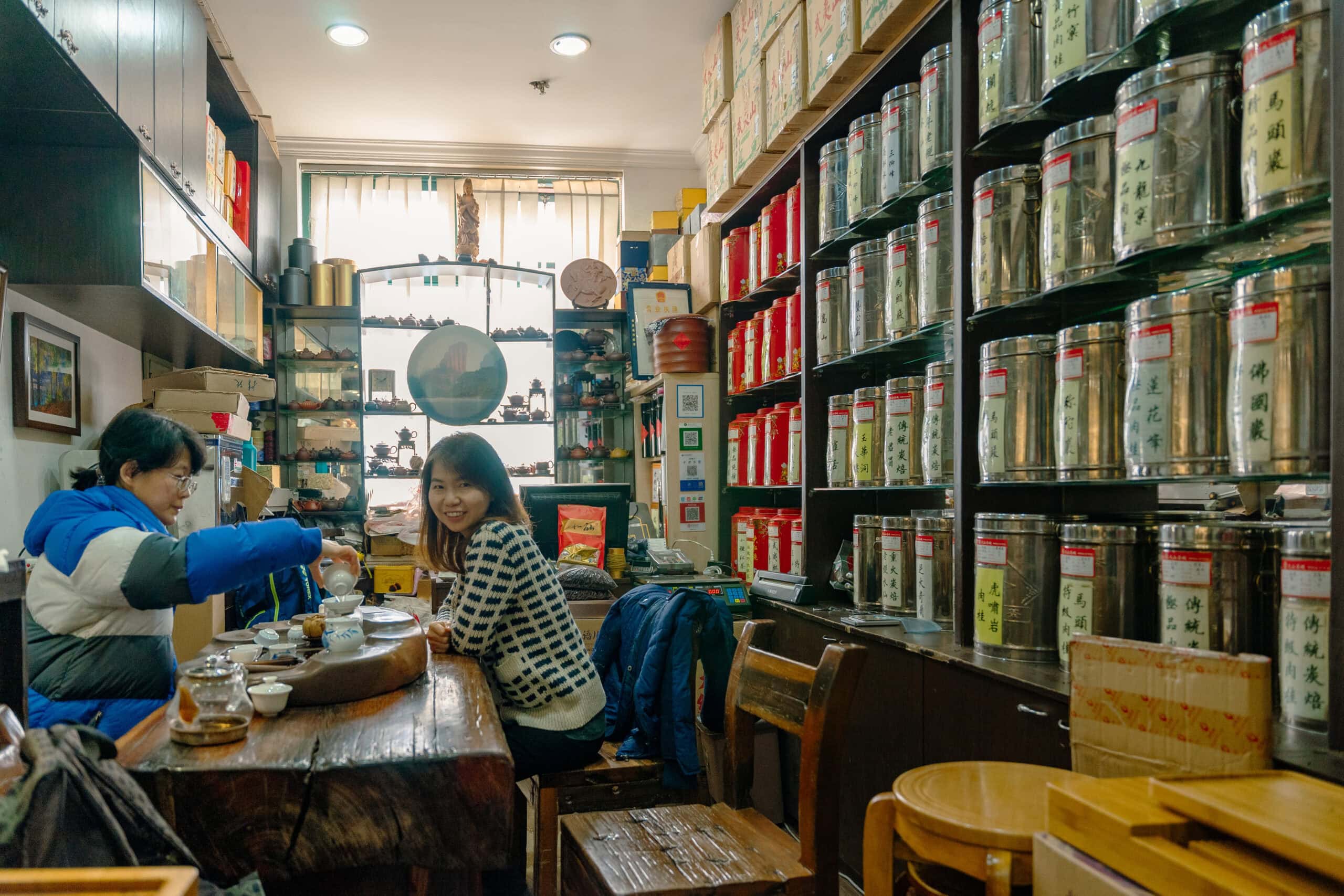 Jin and our hostess in the middle od a tea tasting at shop 2018. Here we are tasting Oolong. One wall of the shop is lines with silver tins full of loose leaf tea