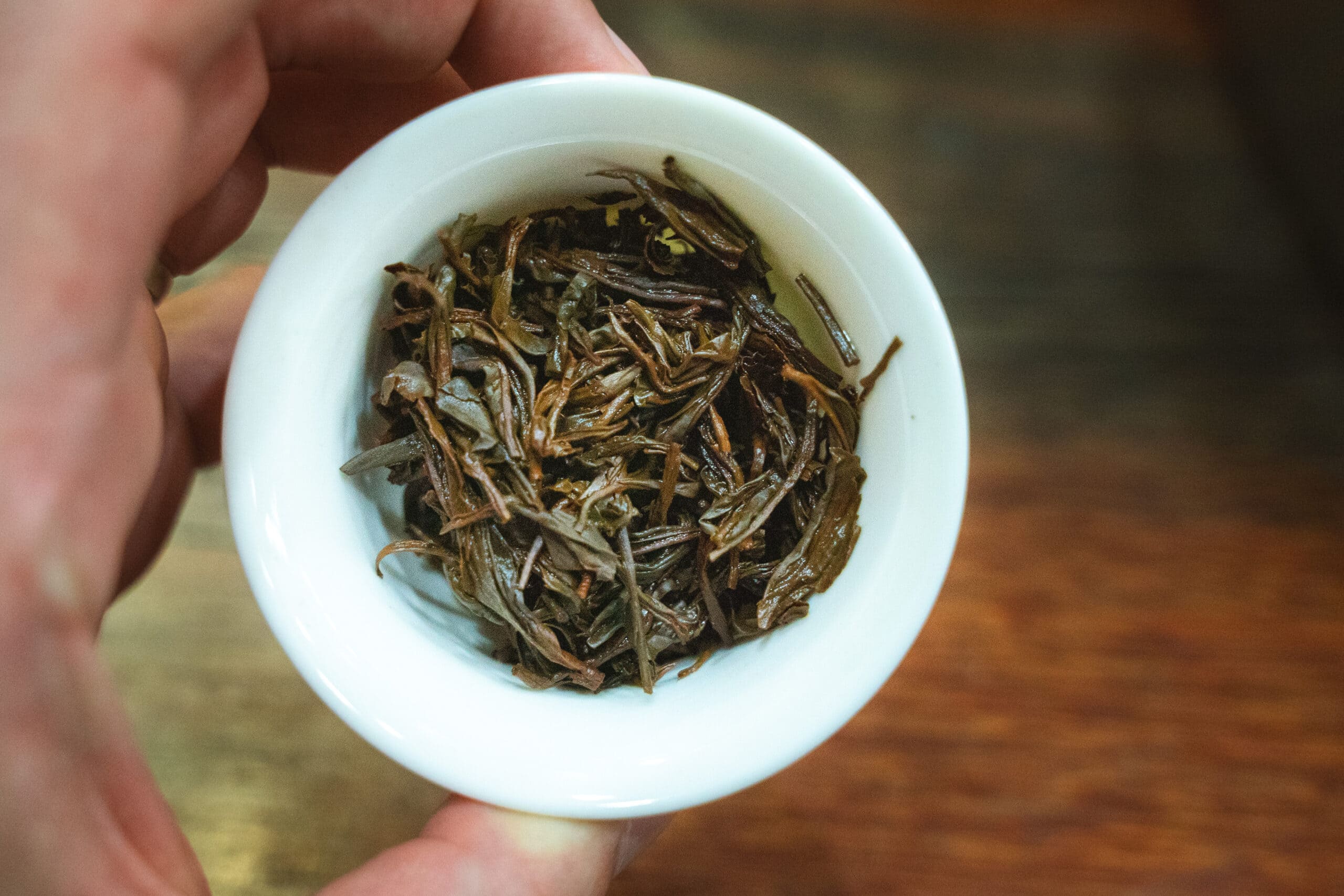 A cup full of soaked oolong loose leaf tea