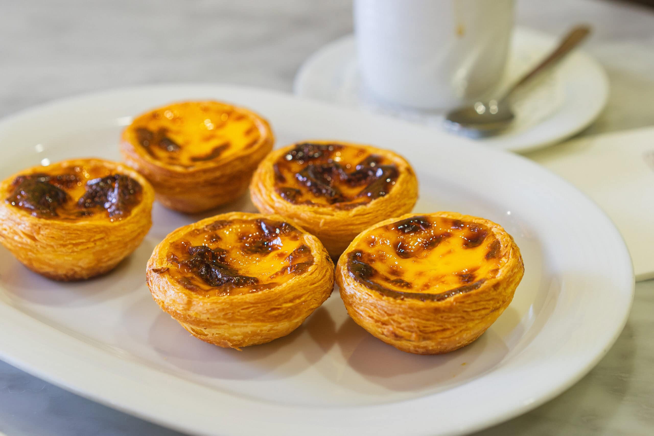 A plate with 5 egg tarts from Lord Stow's original bakery in Coloane