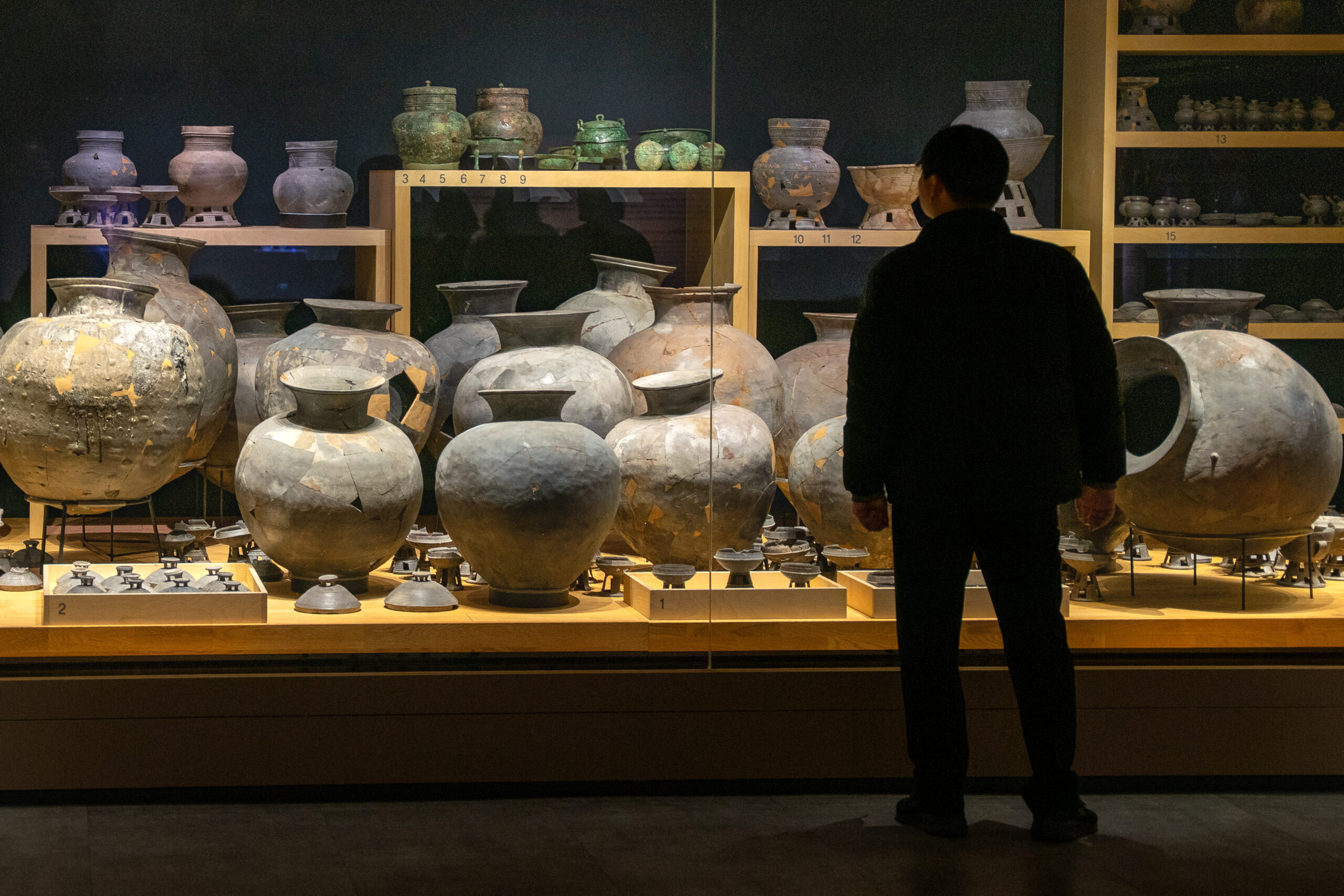 A man looks at pottery displayed in the Gyeongju National Museum, South Korea