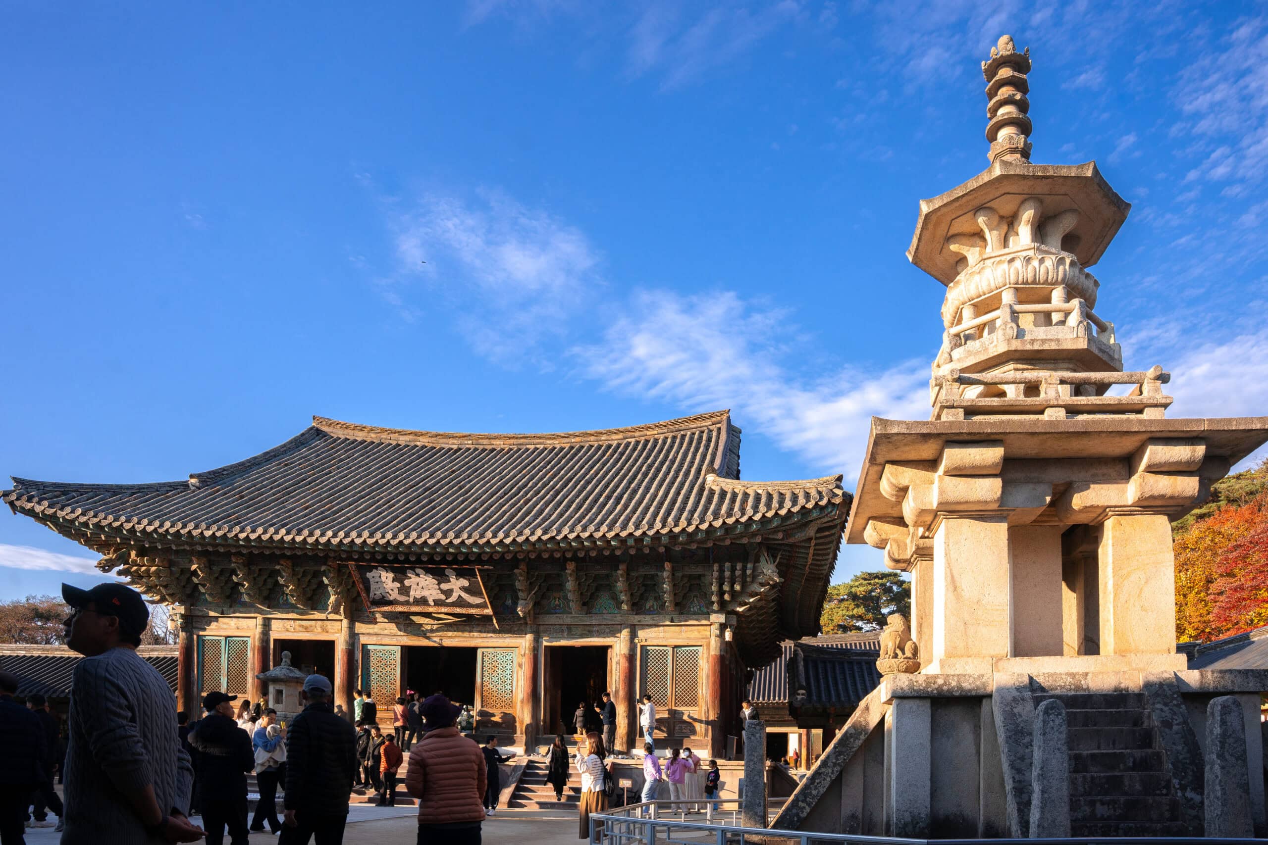 Courtyard at Bulguksa Temple with historic stone pagodas and autumn foliage