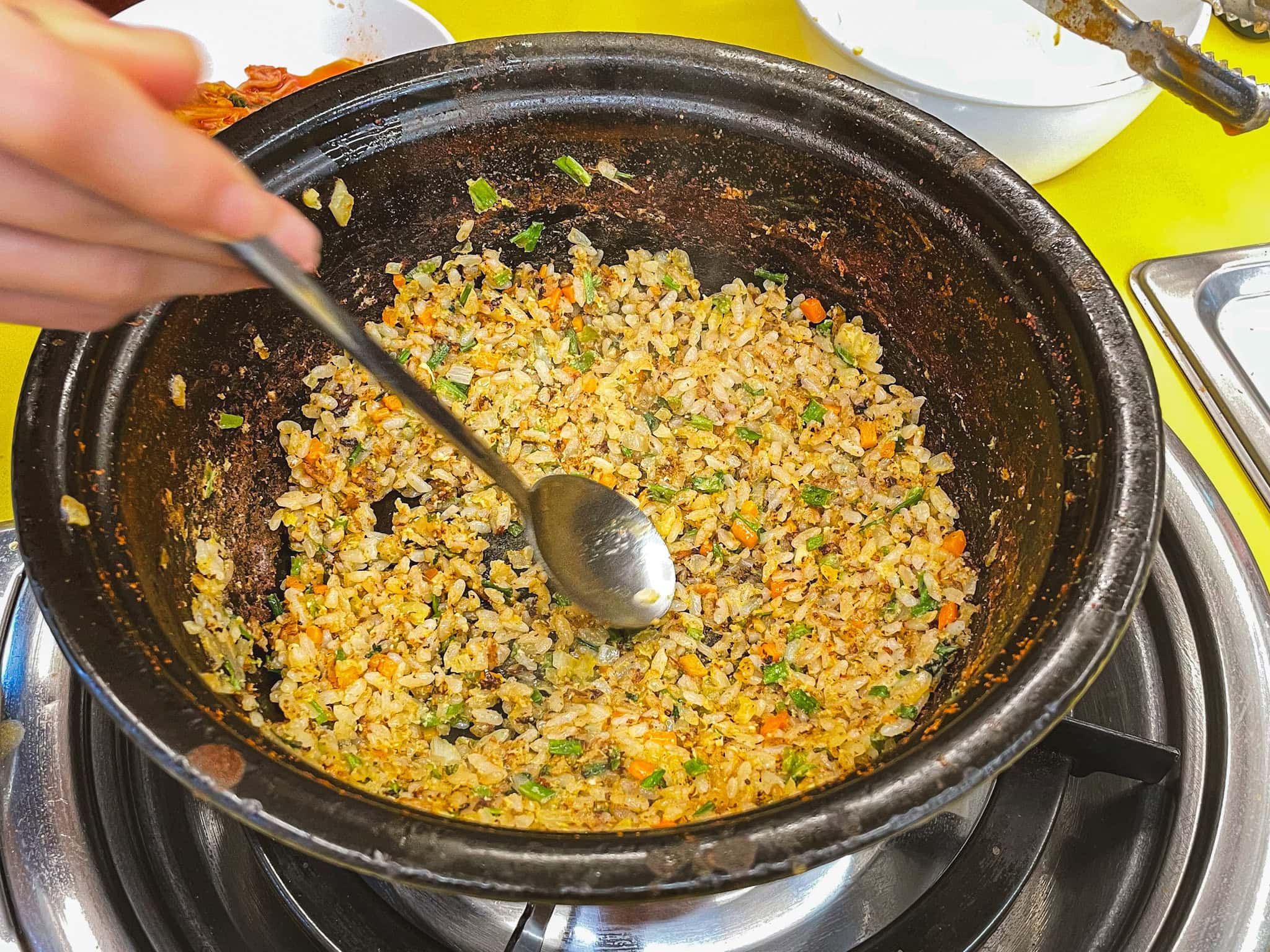 Fried rice at the boittom of the pot, which is the last step when eating at Deungchon Kalguksu
