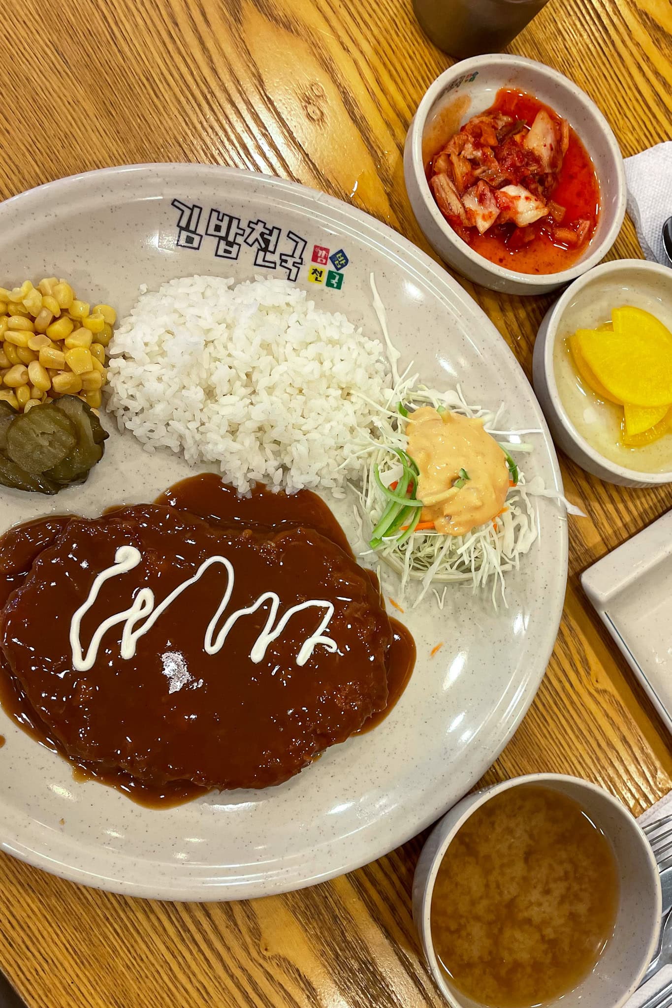 A plate of donkas covered in sauce from Kimbap Cheonguk in Seoul