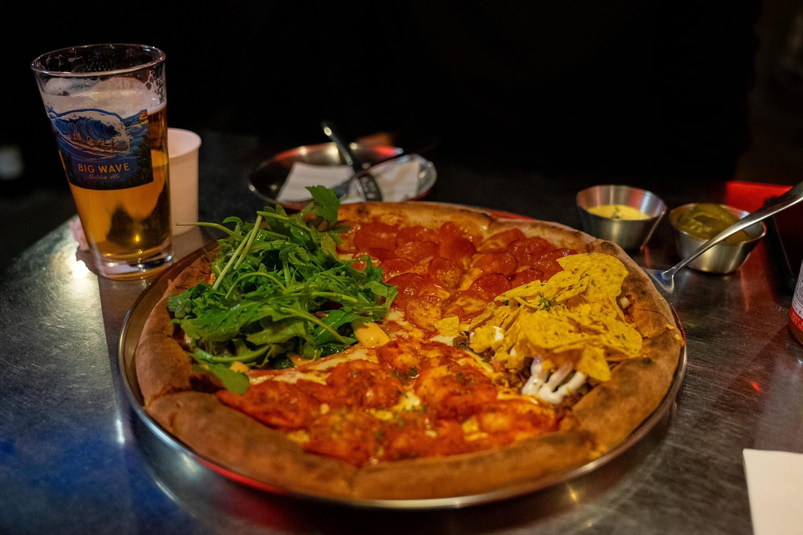 A four-way split pepperoni and spicy shrimp pizza at Dallas Pizza in the industrial Mullae-dong neighborhood.