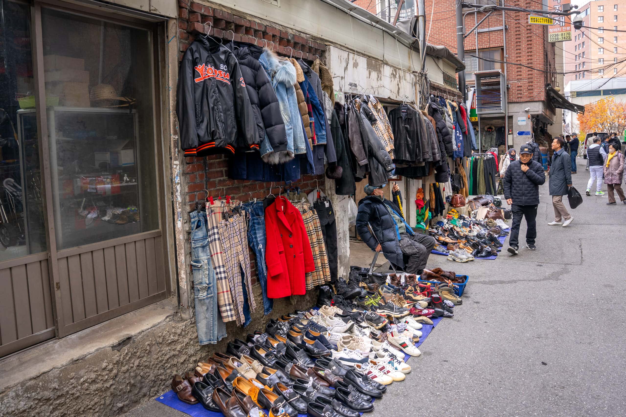 Second hand clothes and shoes for sale on the streets of Dongmyo market in Seoul