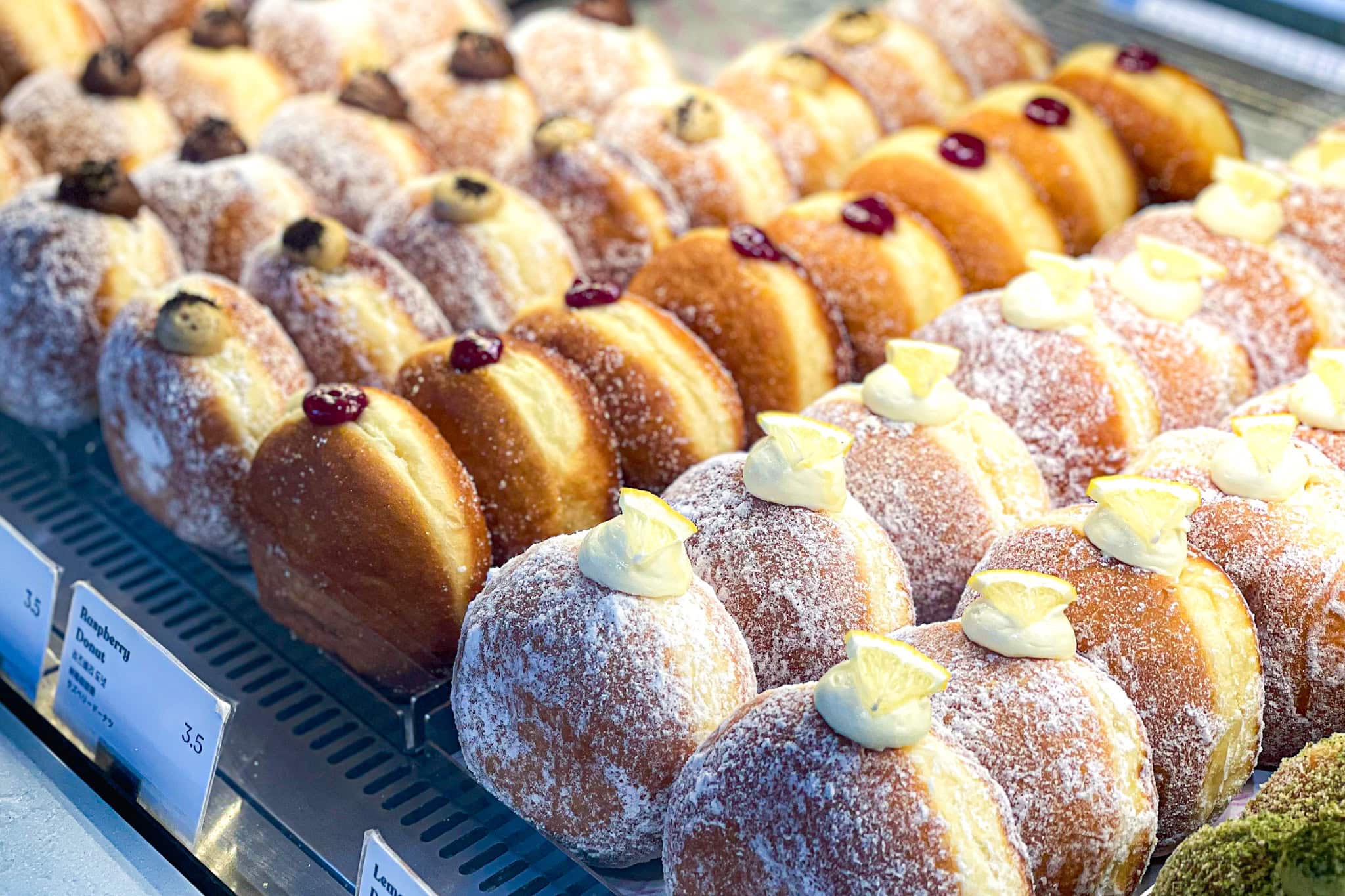 a large selection of donuts in the display cabinet at Knotted donuts in Anguk, Seoul