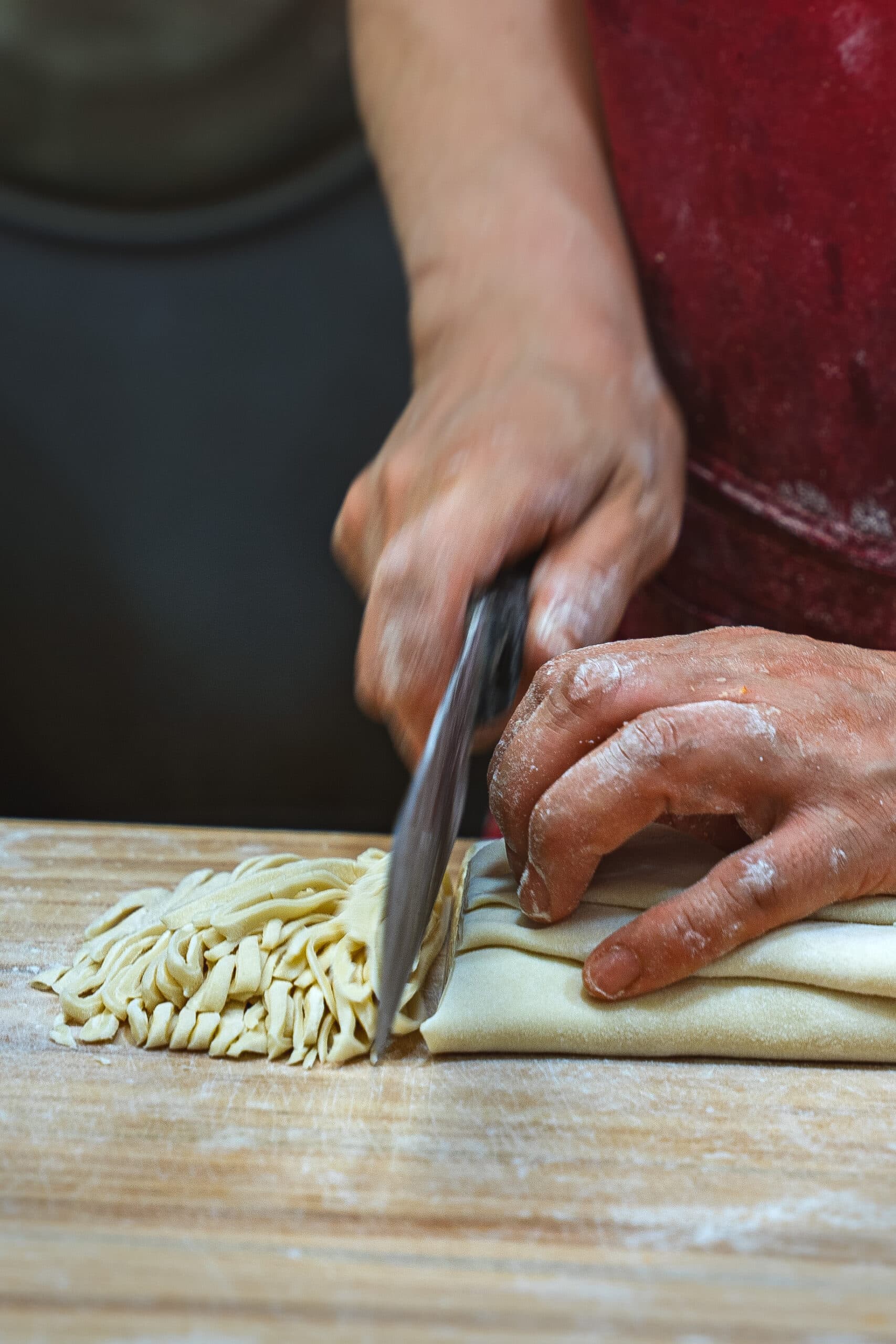 a close up of kalguksu getting cut by a knife