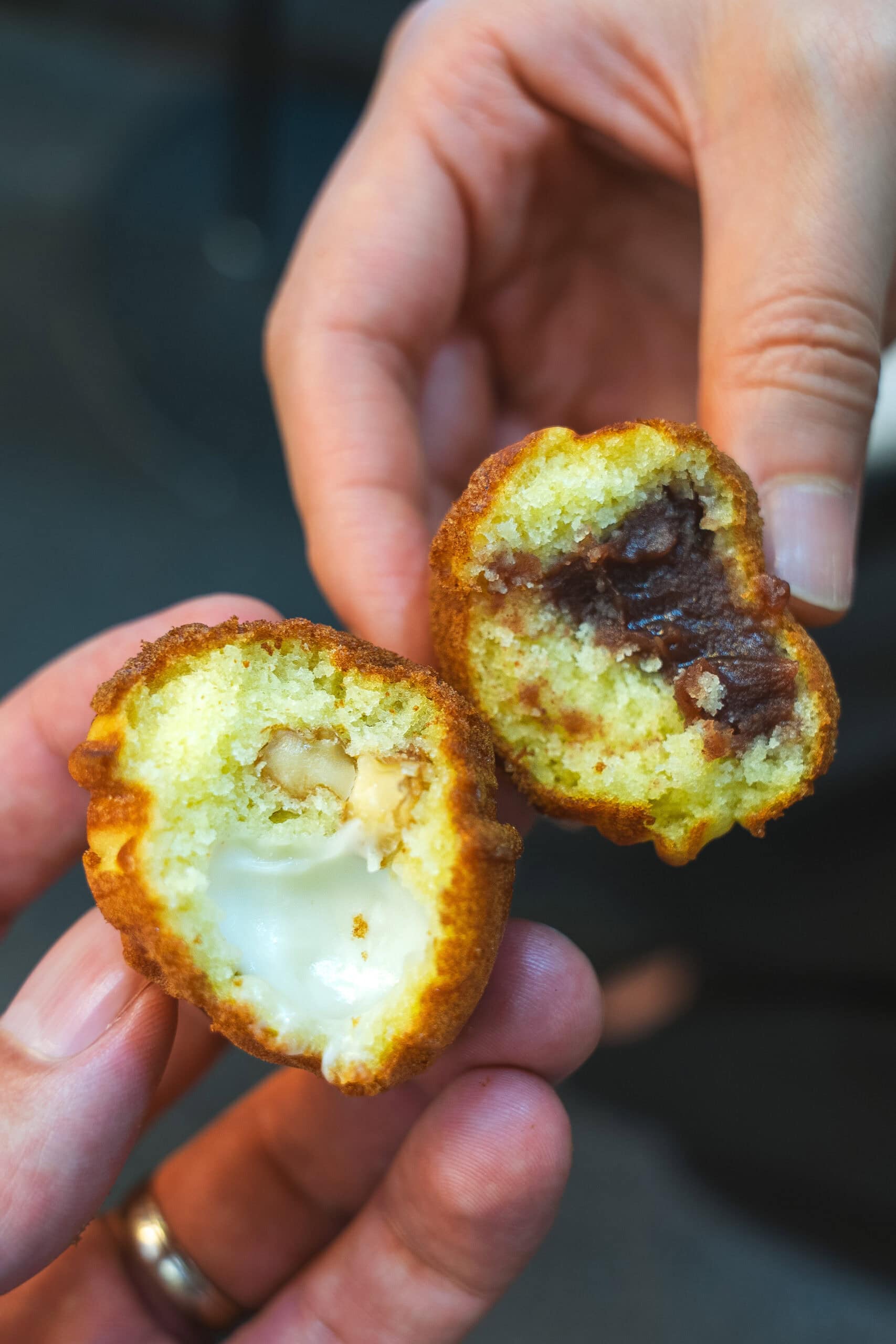 Two hodo gwaja bitten in half, showing one filled with vanilla cream and the other with red bean paste