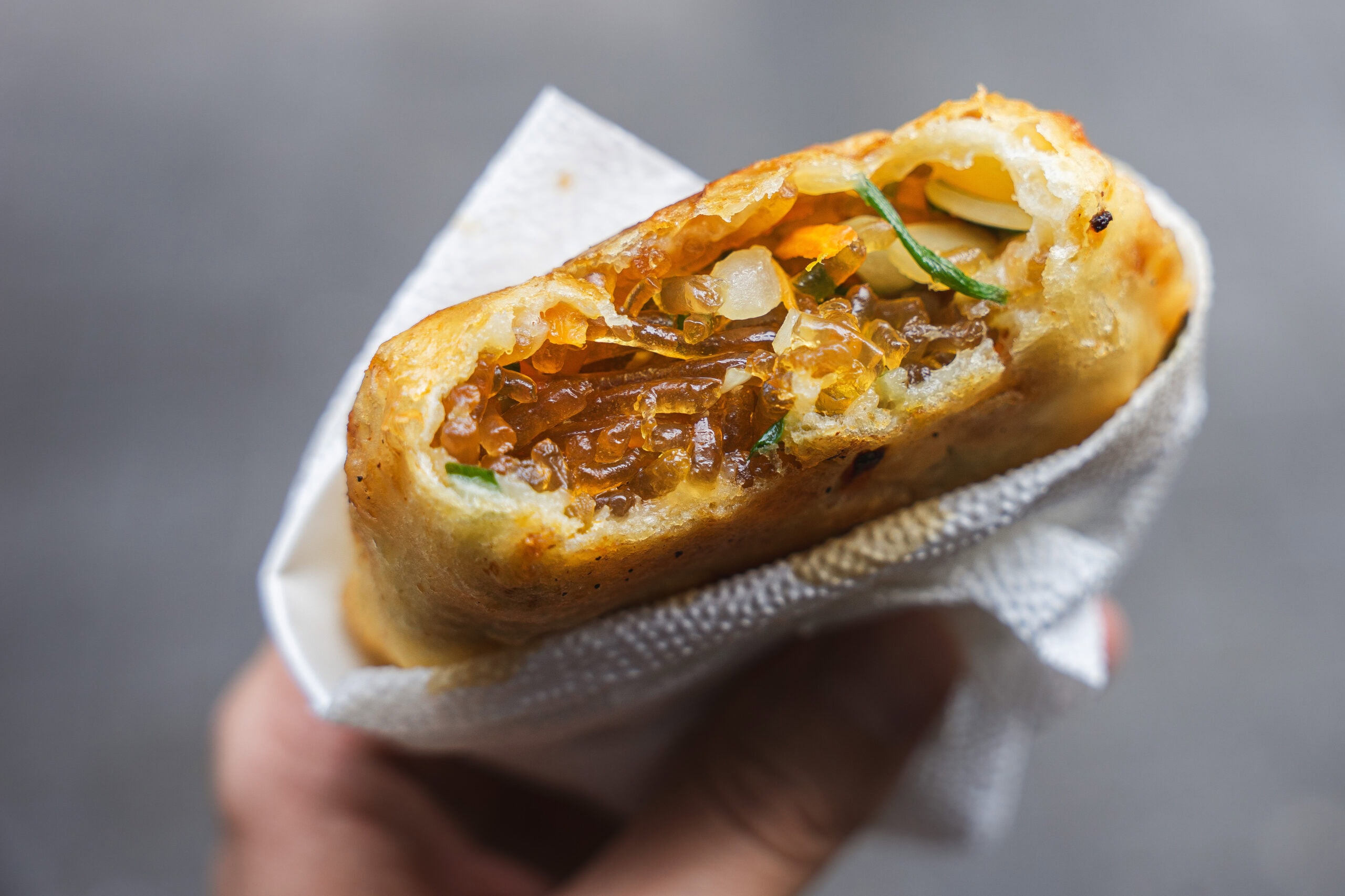 A golden fried vegetable hotteok from Namdaemun in Seoul, filled with vegetables and glass noodles.