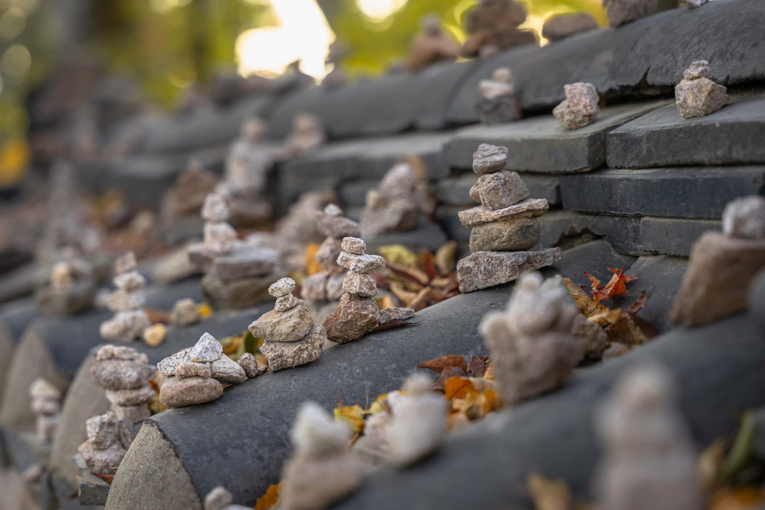 Temporary stone pagodas built by visitors along a temple wall