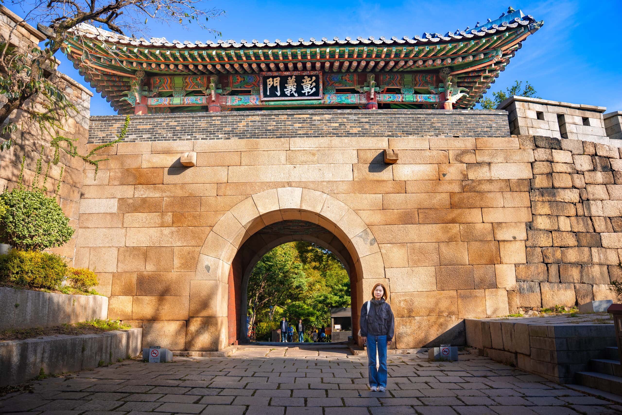 Jin stands in front of the Changuimun Gate in Buam-dong
