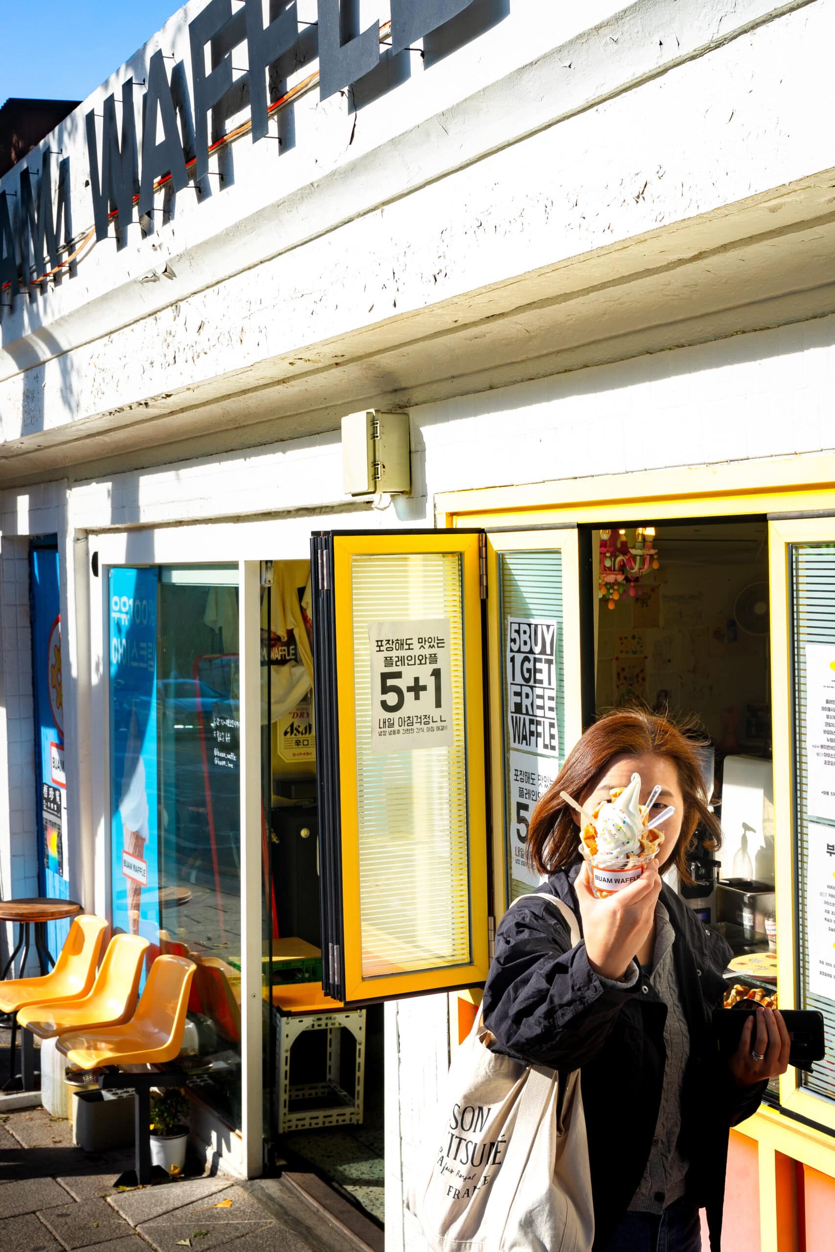 Jin is a bit camera shy and tries to hide behind the ice cream cup she holds up in front of her face