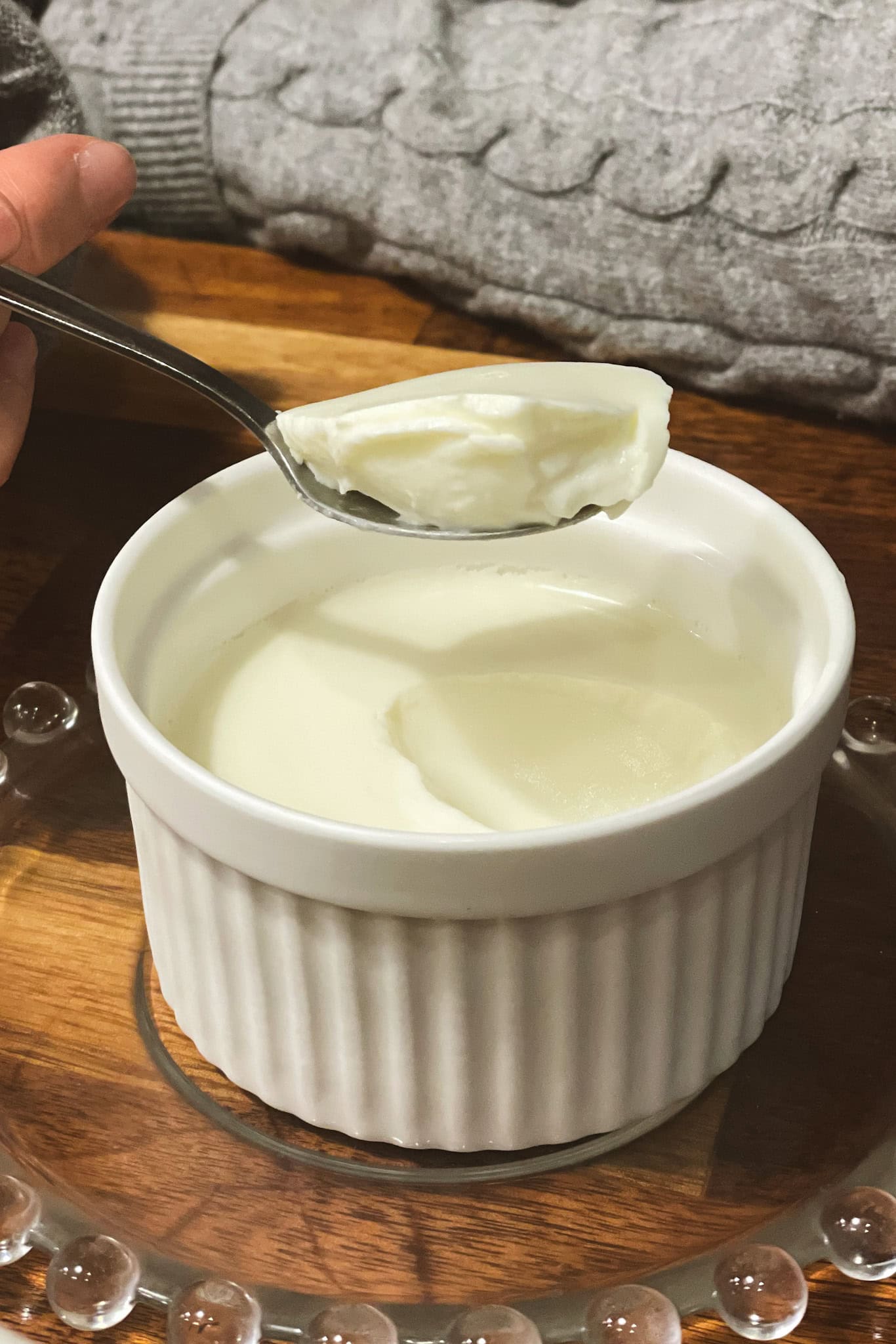 Jin scoops out a spoon of milk pudding