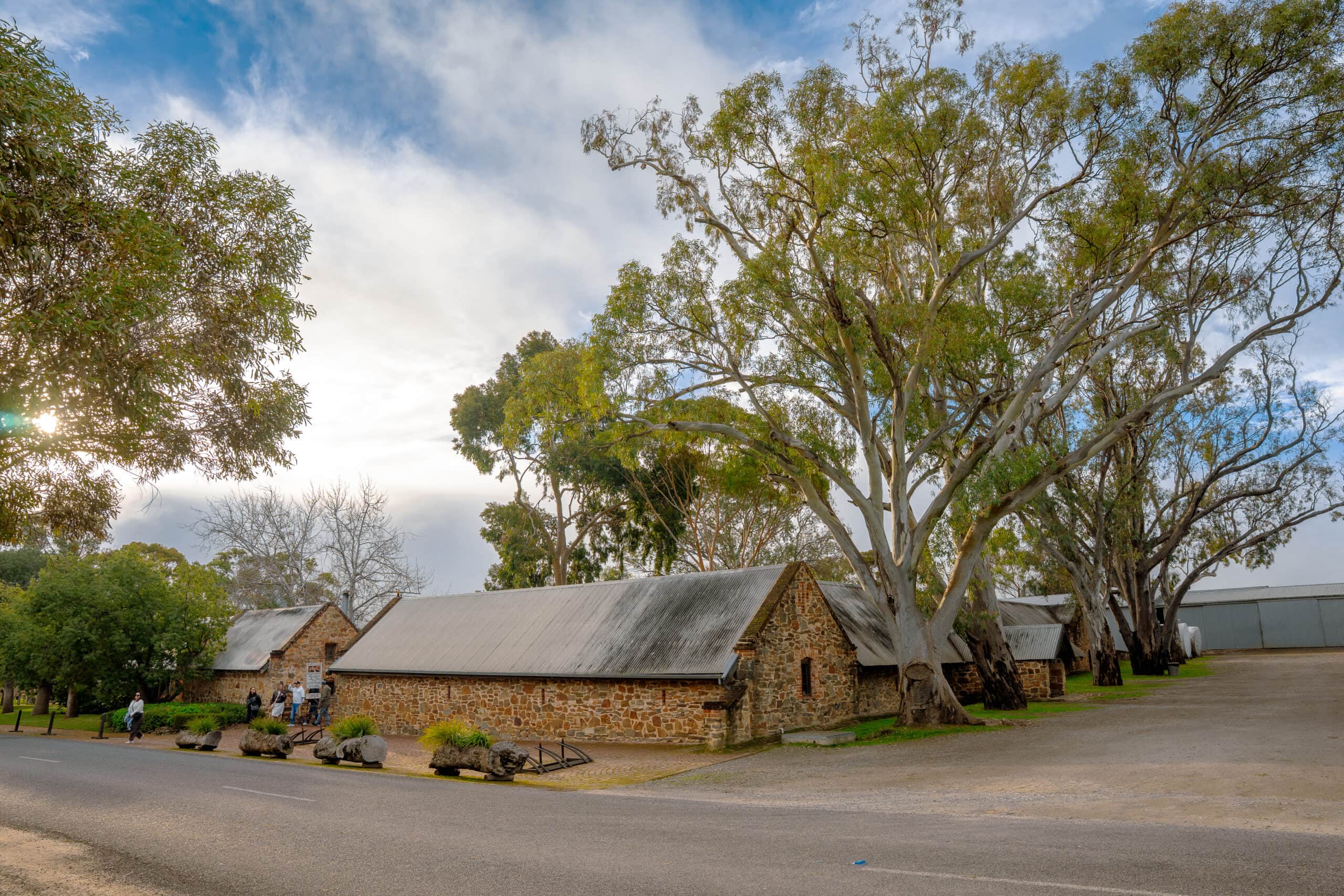 Low stone buildings of Rockford Wines stand under tall gum trees, Barossa Valley, South Australia