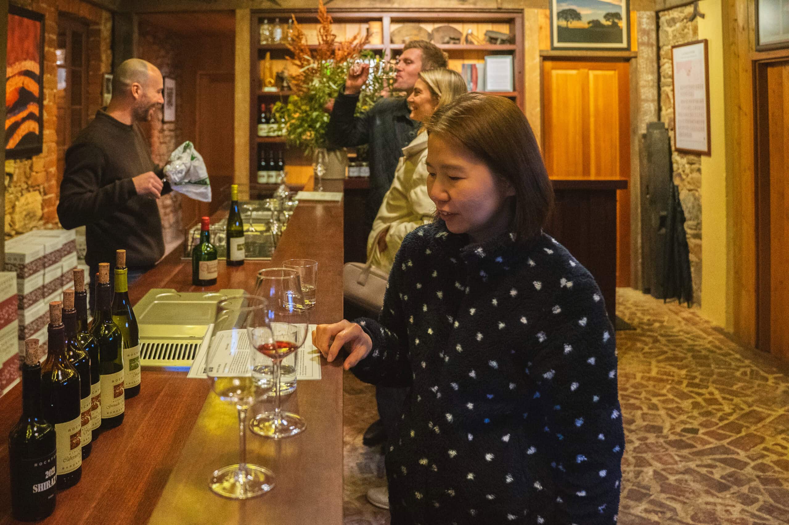 Jin enjoying wine tasting at Rockford Wines in Barossa. Another couple behind her are knocking back a glass of wine too