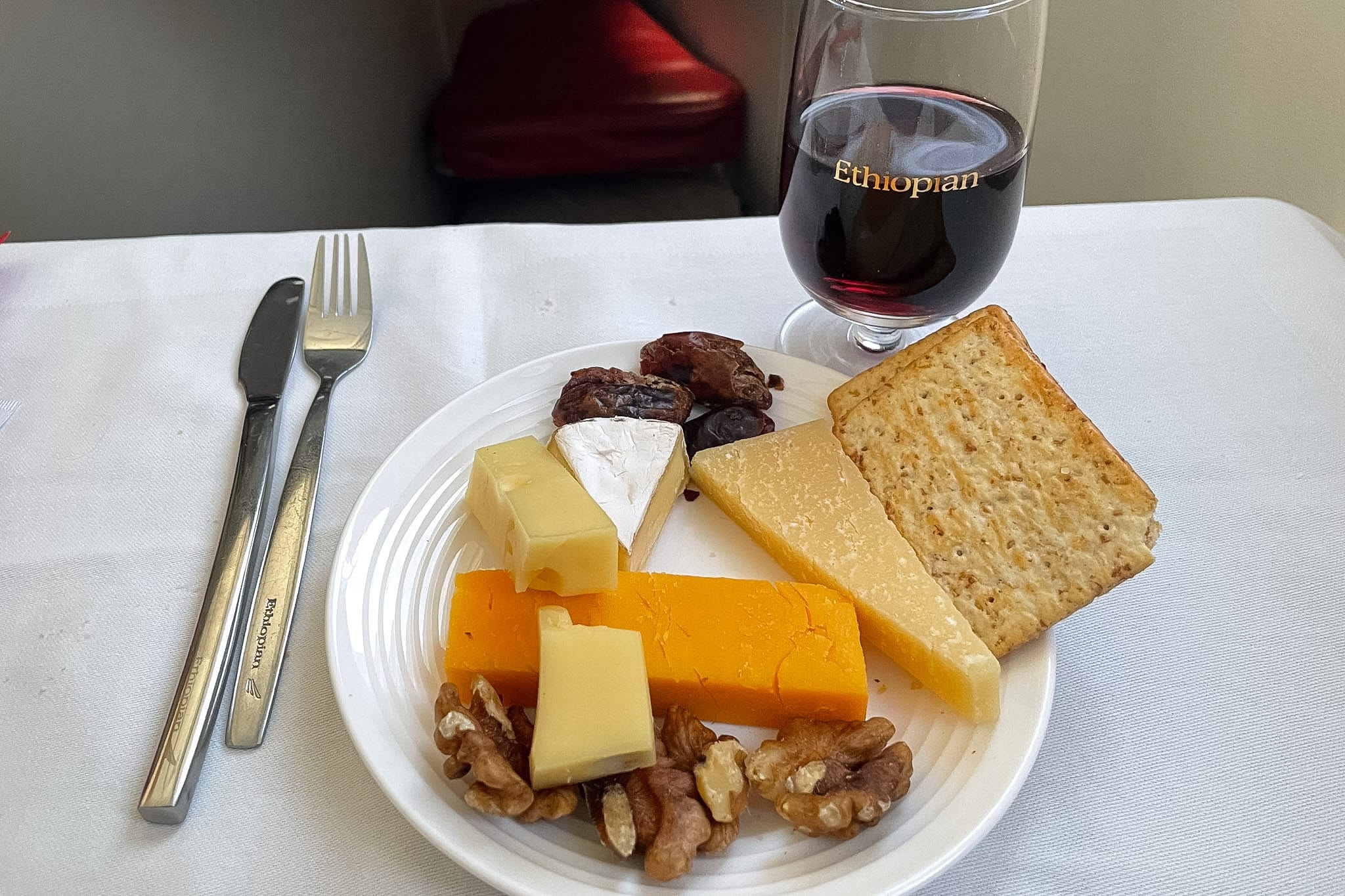 Cheese platter with crackers, dates, and walnuts with a glass of port I had for dessert on Ethiopian Airlines Cloud 9