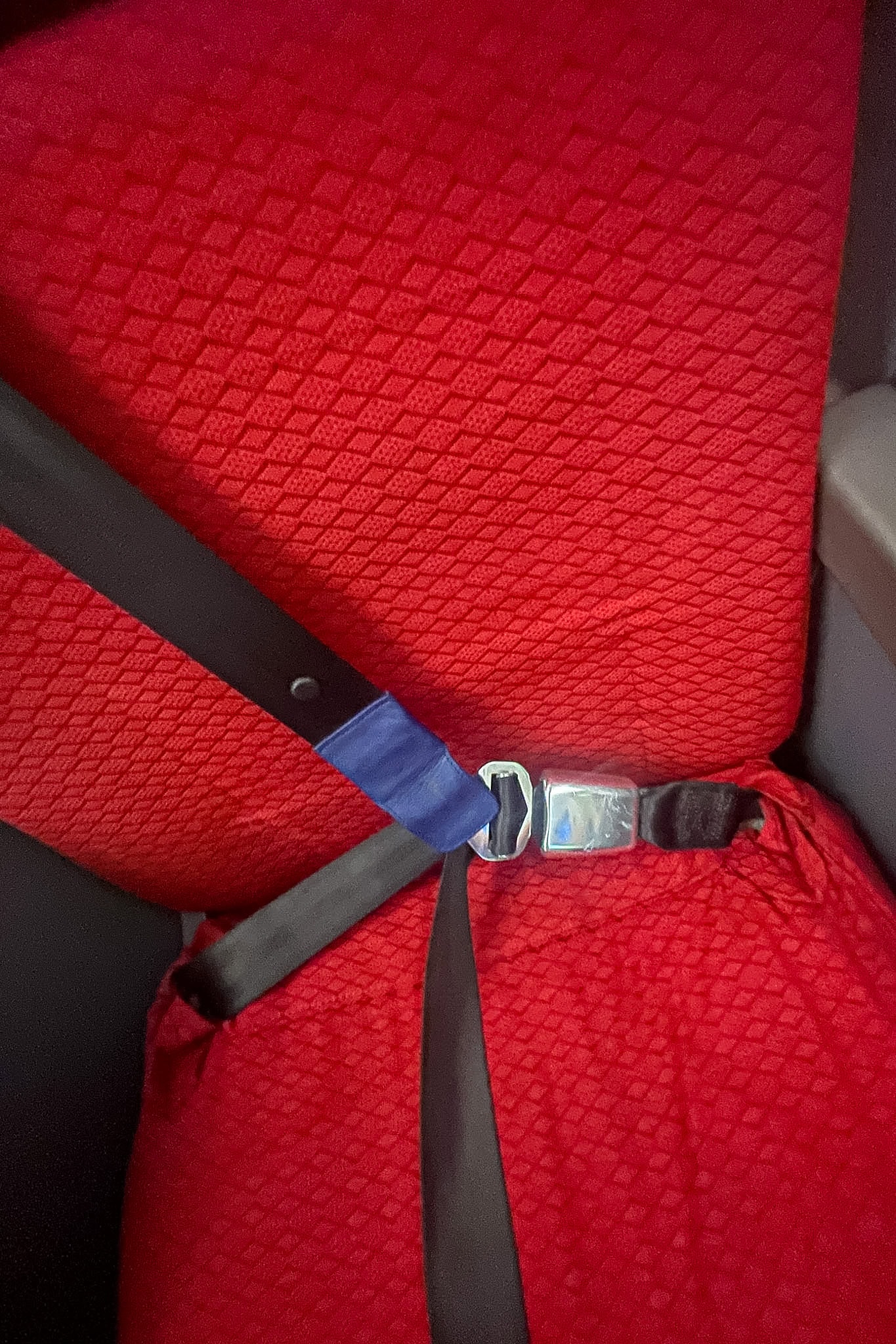Shoulder seat belt across a bright red seat of Ethiopian Airlines Business class A350