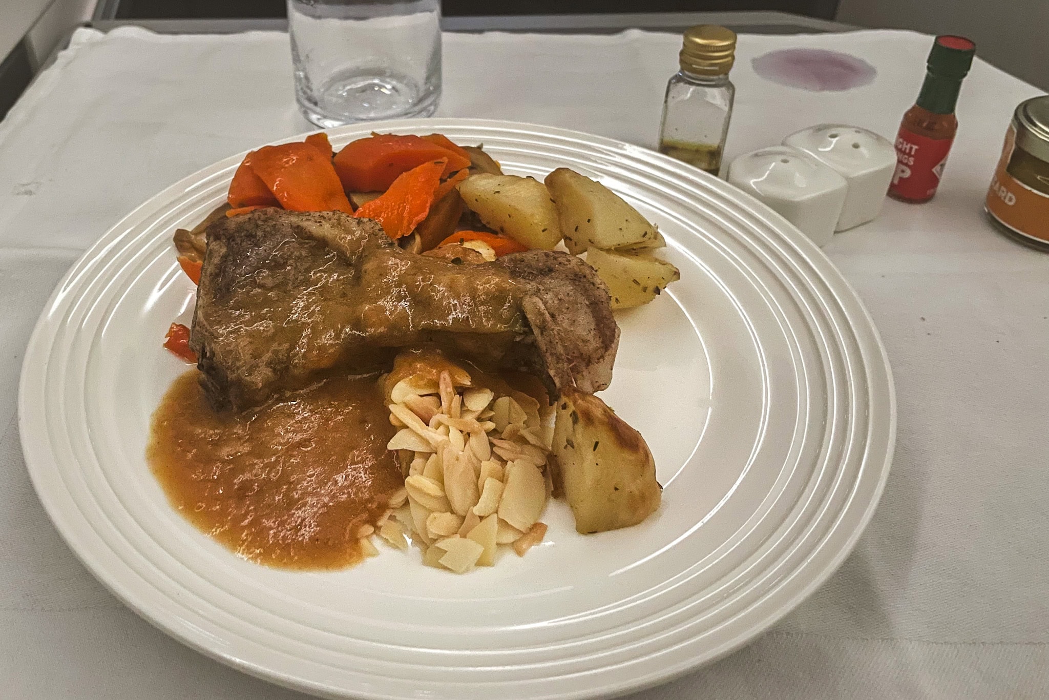 Lamb cutlet served with potatoes, carrots, gravy and almonds that. I had for dinner