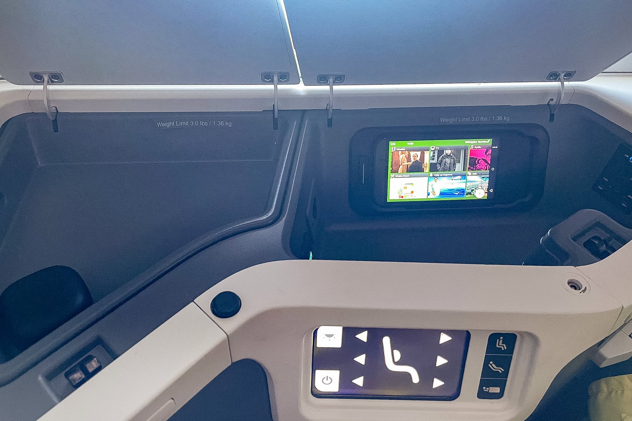 Storage compartment with digital remote control for IFE, power sockets, and USB ports inside the A350 Ethiopian Airlines Business class