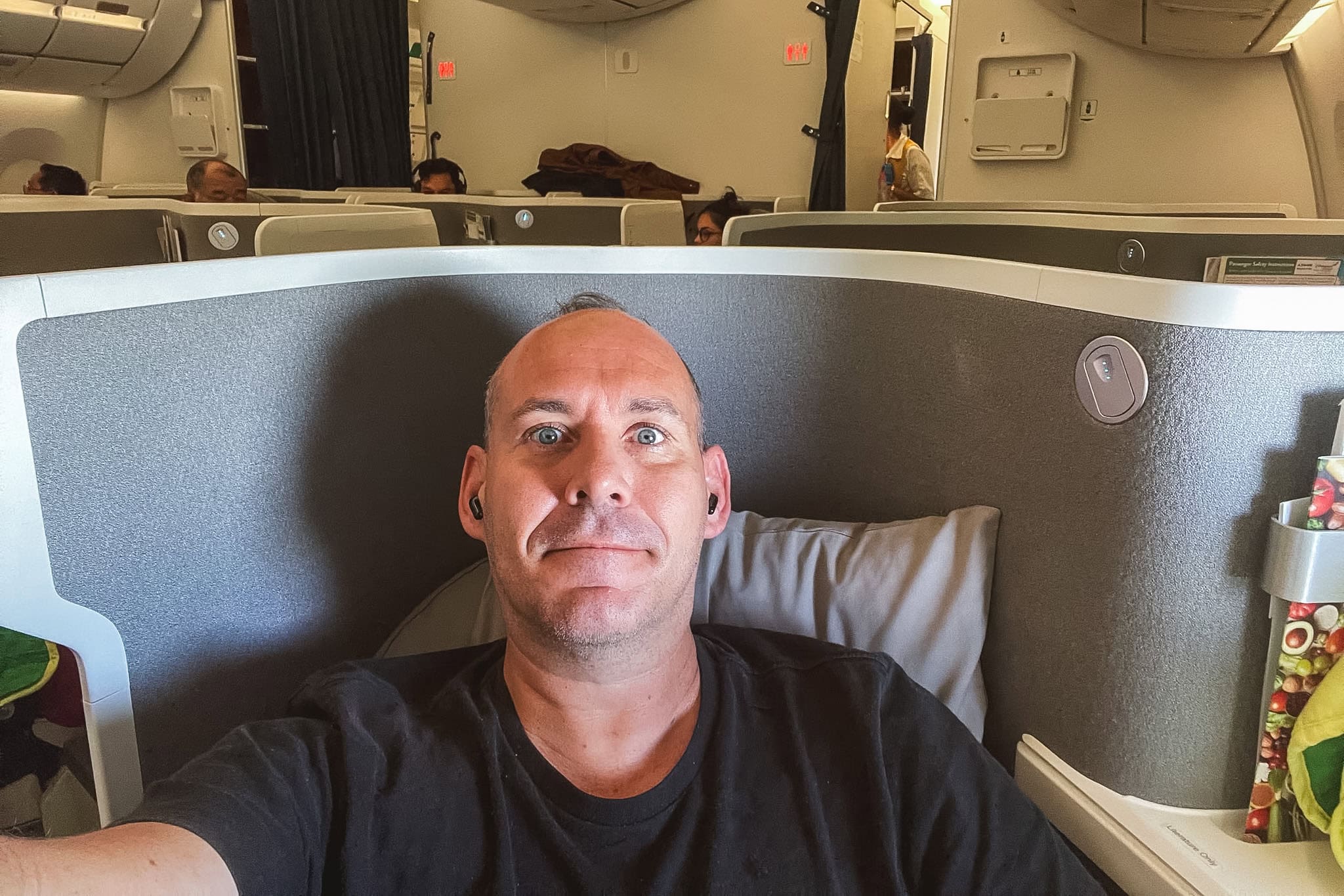 A handheld phone selfie of me in Ethiopian Airlines business class from Addis Ababa to Seoul on the A350